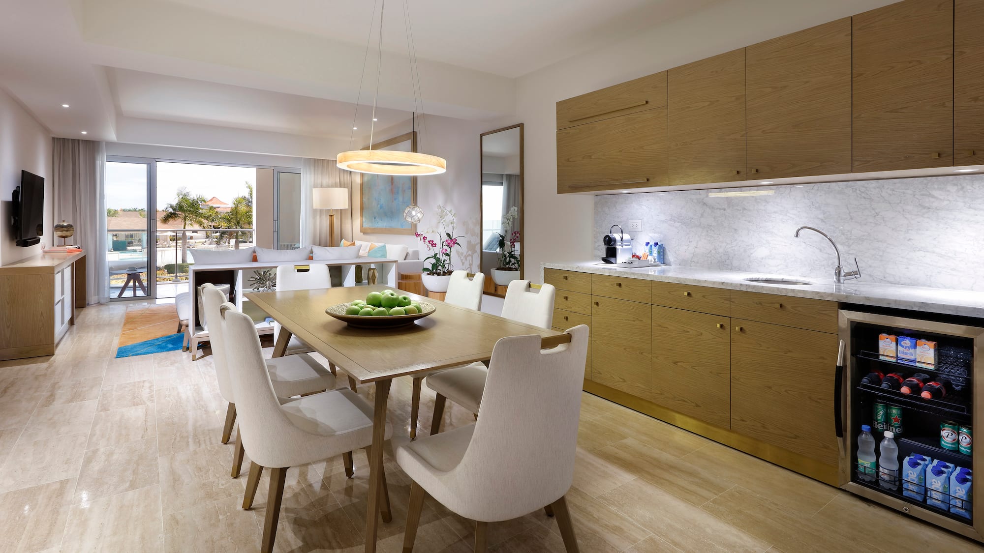 a dining table and kitchen with wood cabinets