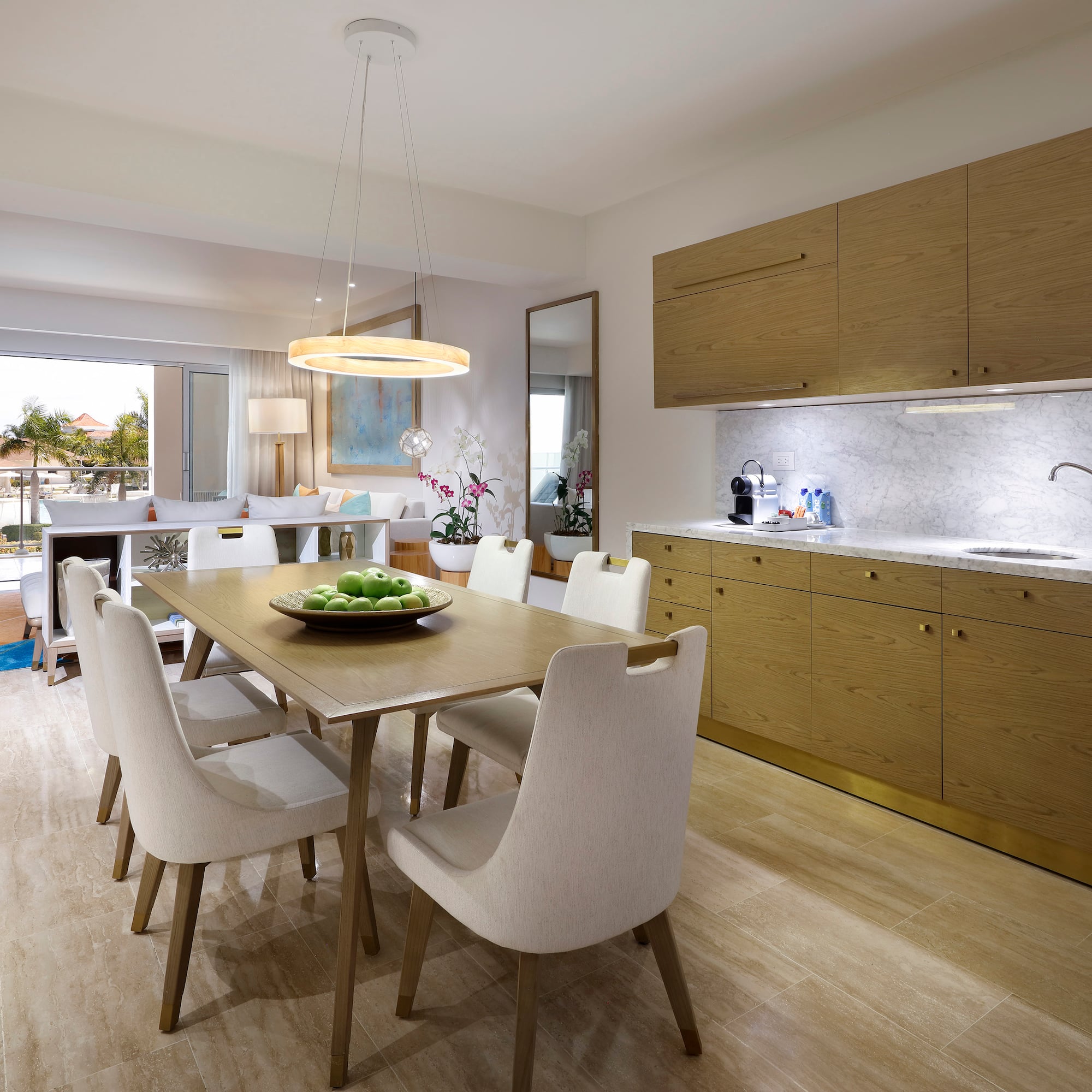 a dining table and kitchen with wood cabinets
