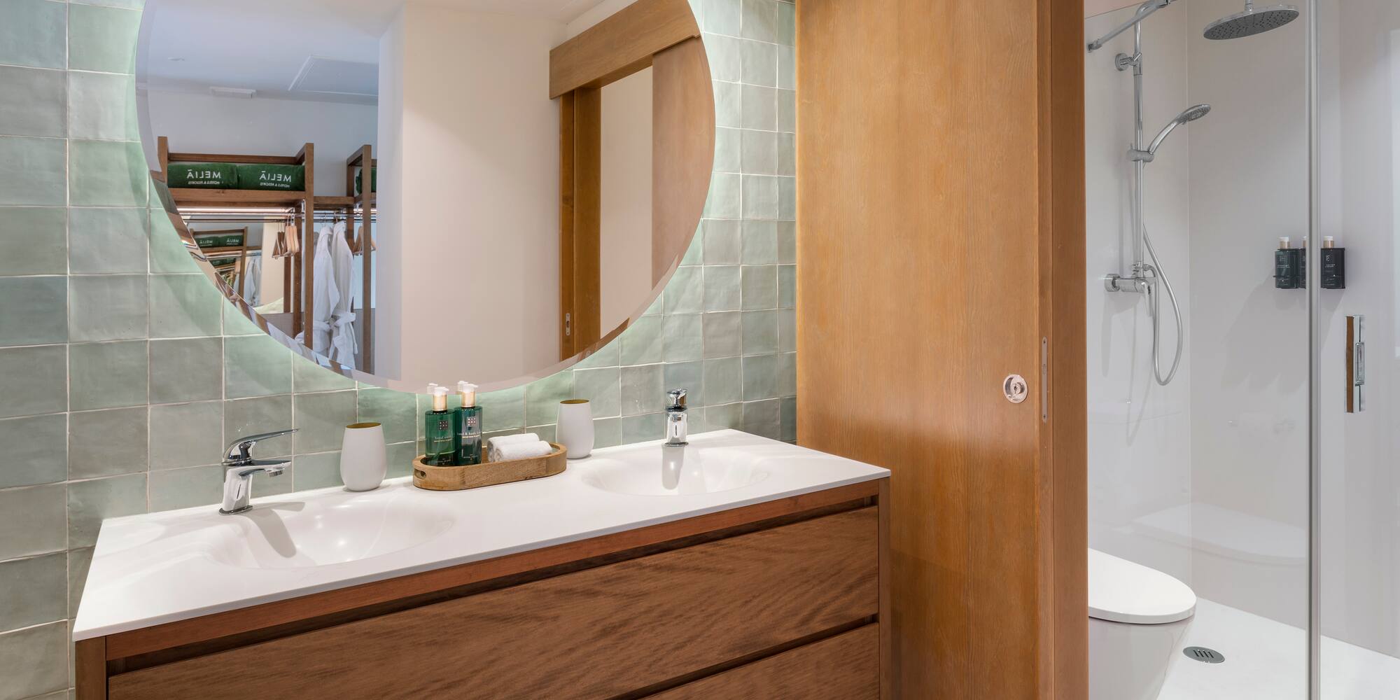 a bathroom with a round mirror