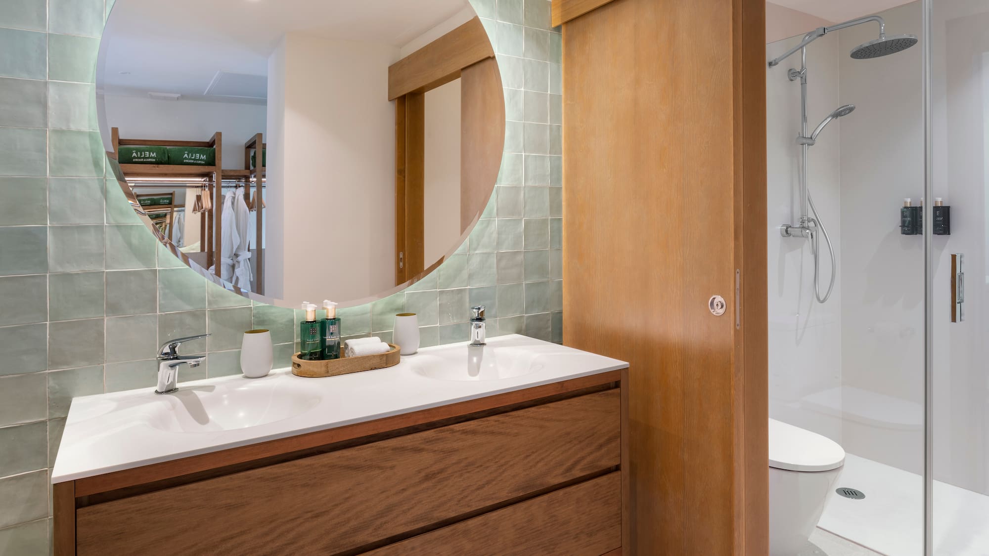a bathroom with a round mirror