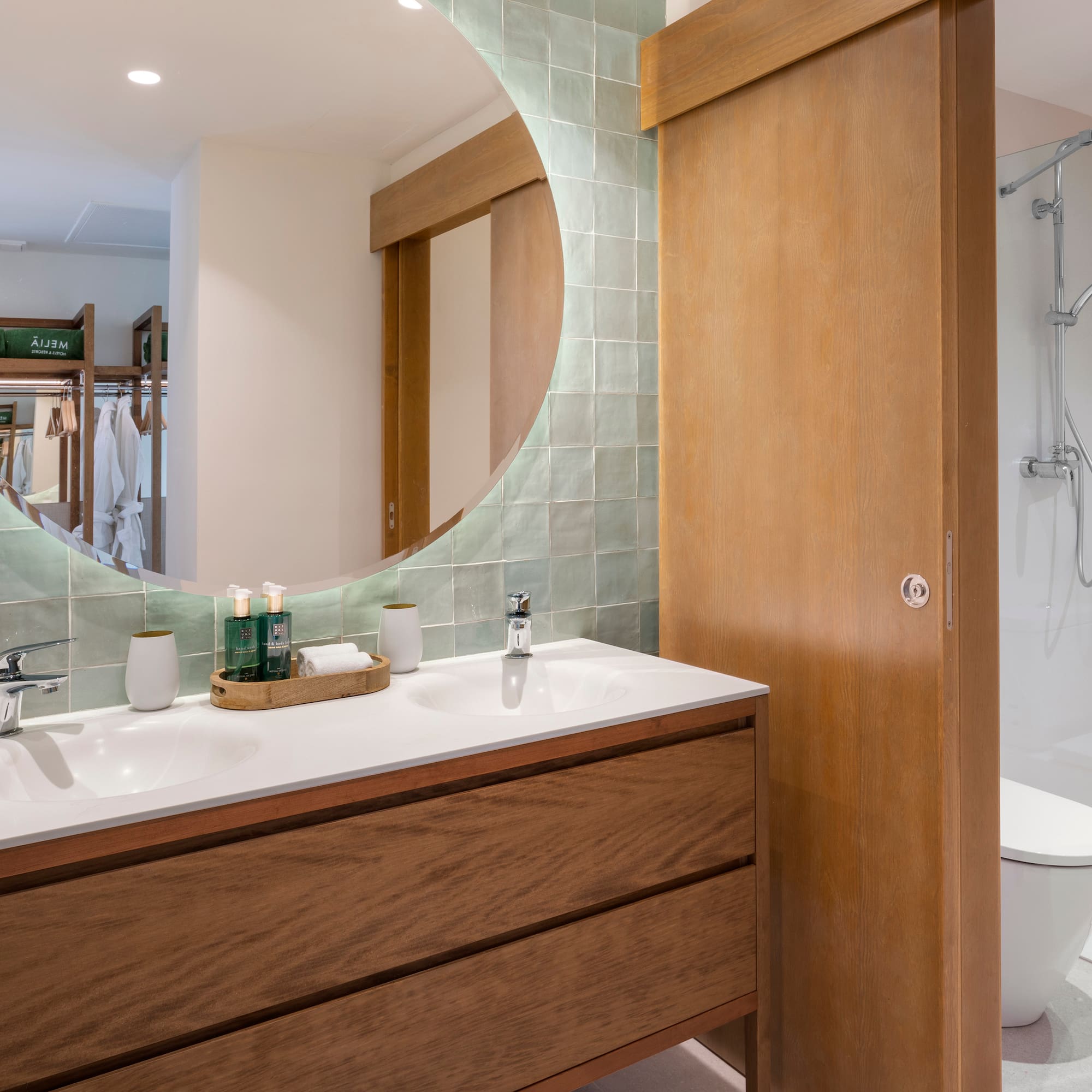 a bathroom with a round mirror