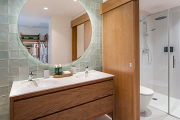 a bathroom with a round mirror
