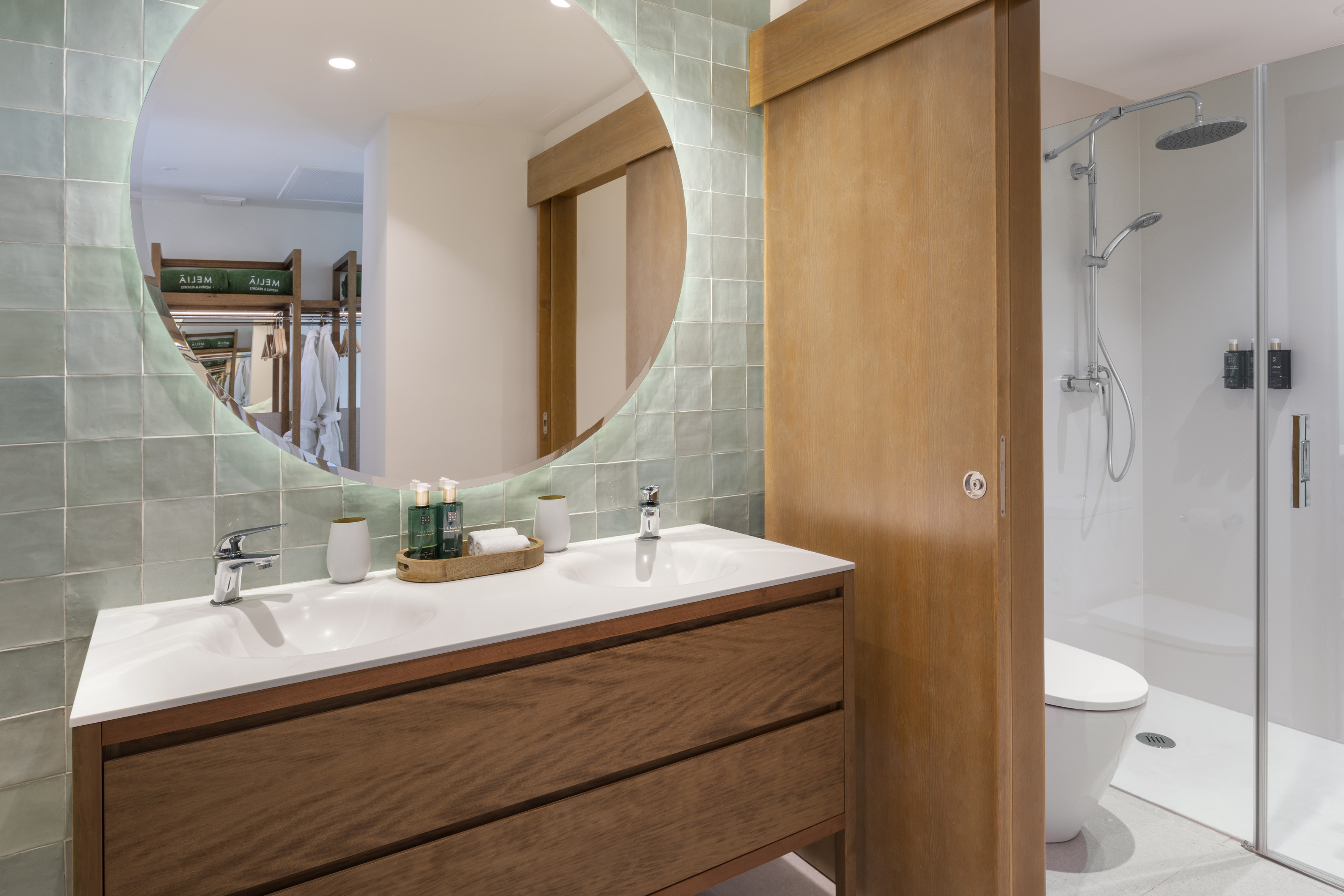 a bathroom with a round mirror