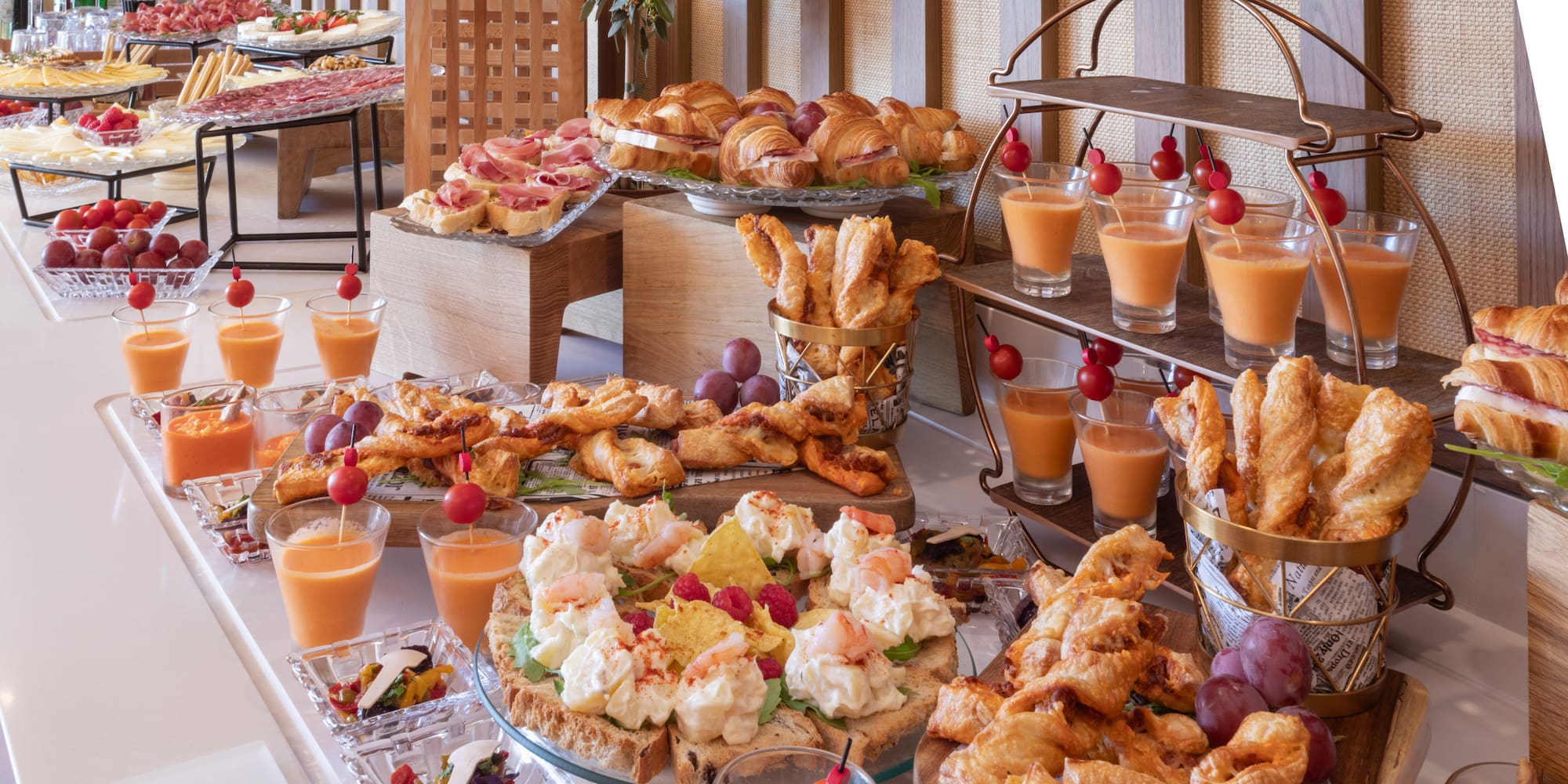 a room with white walls and white walls and a white floor with white chairs and a table with plants