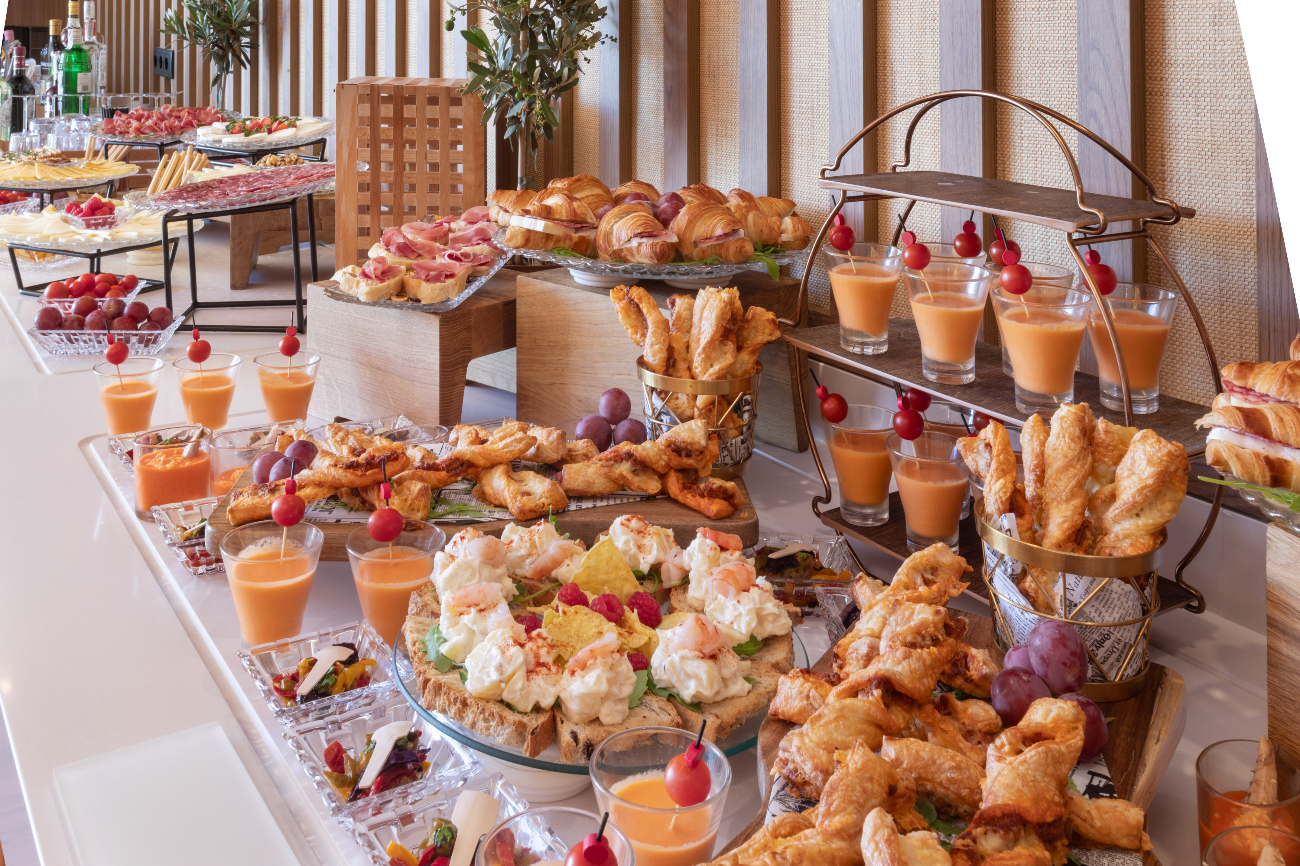 a room with white walls and white walls and a white floor with white chairs and a table with plants
