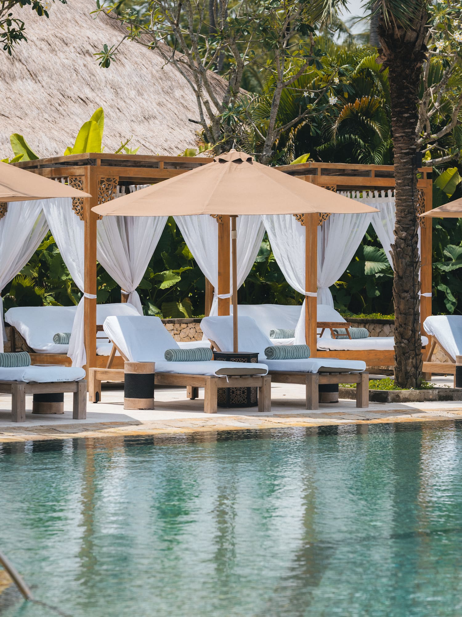 a pool with lounge chairs and umbrellas