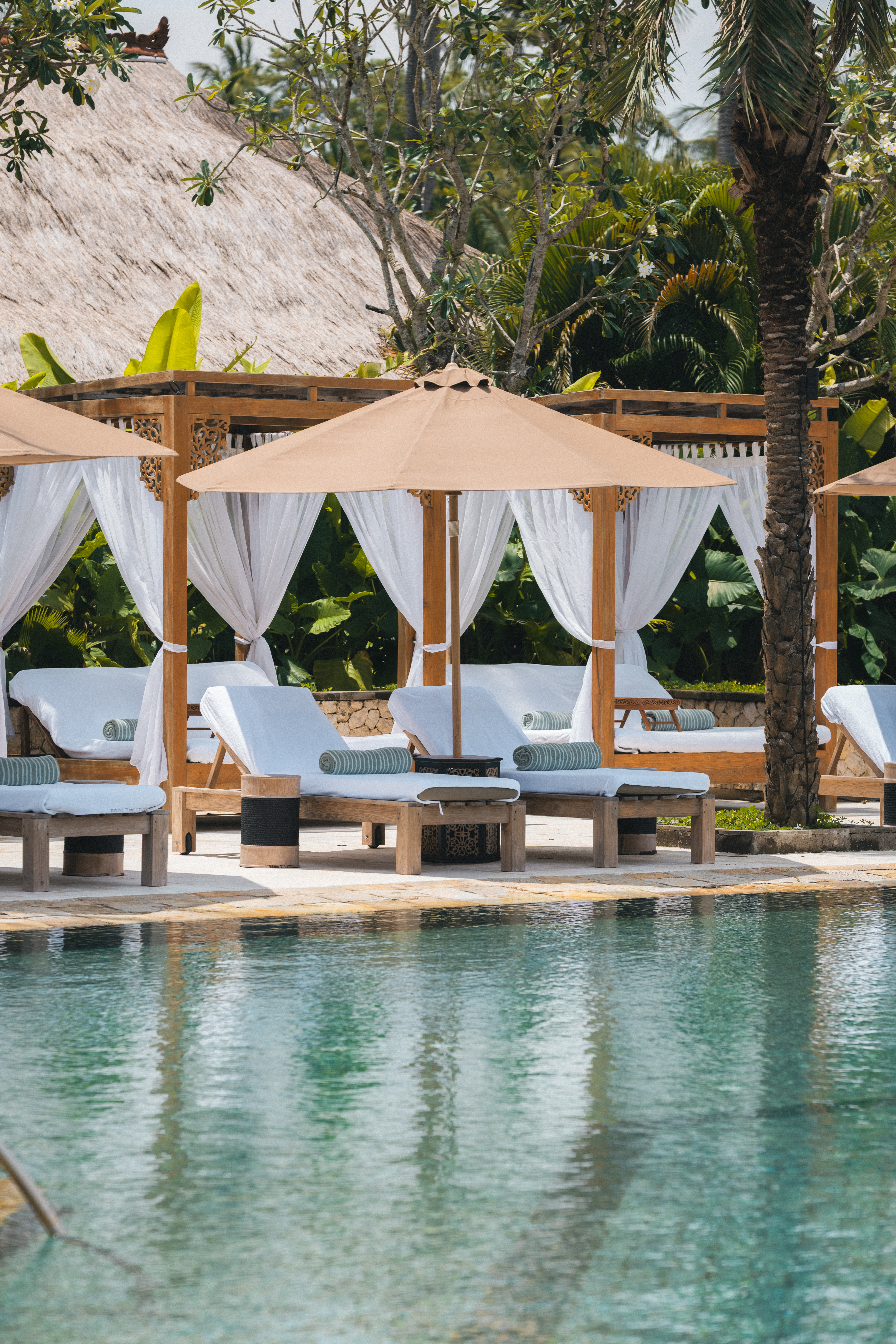 a pool with lounge chairs and umbrellas