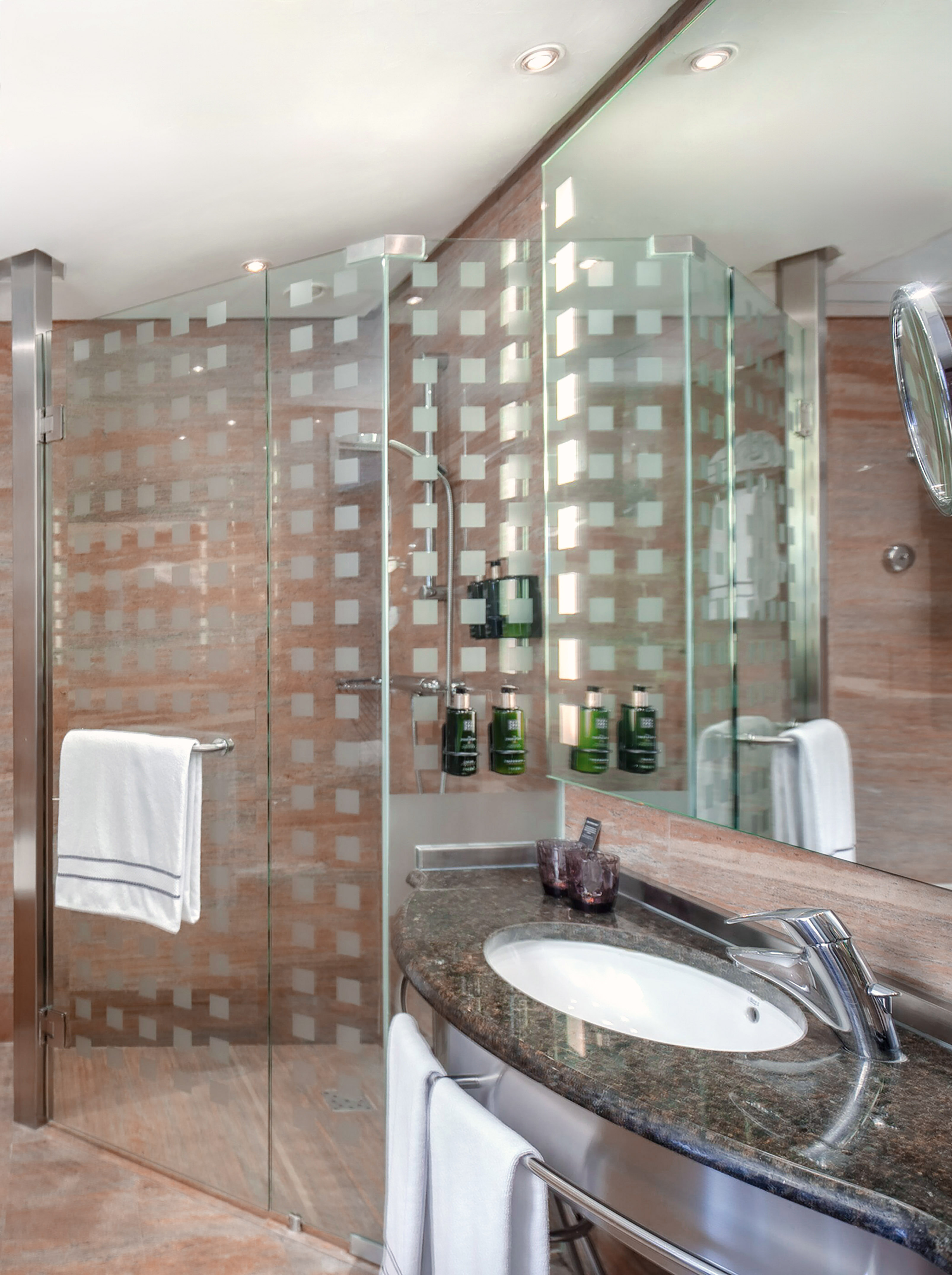 a bathroom with a glass shower and sink