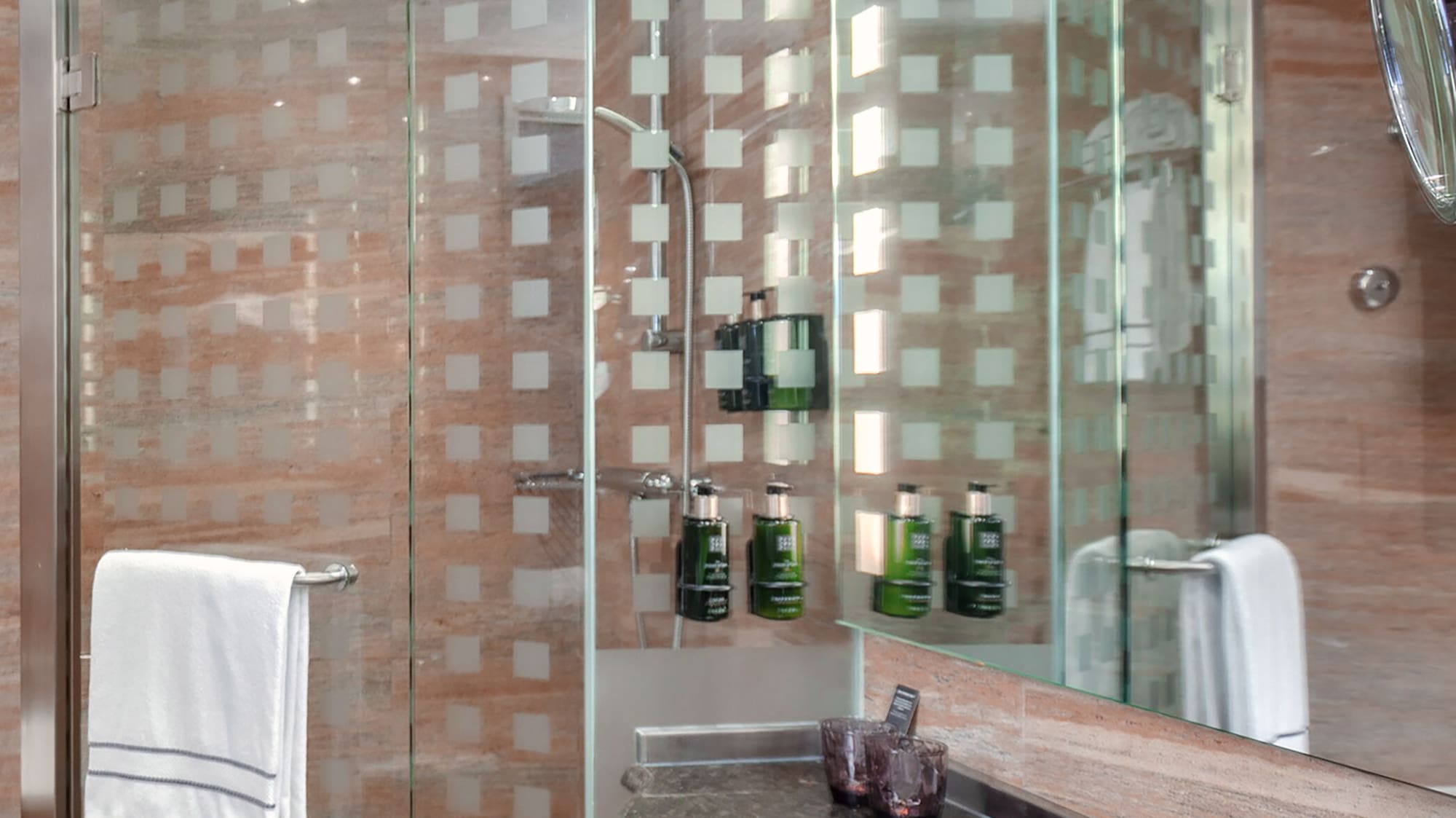 a bathroom with a glass shower and sink