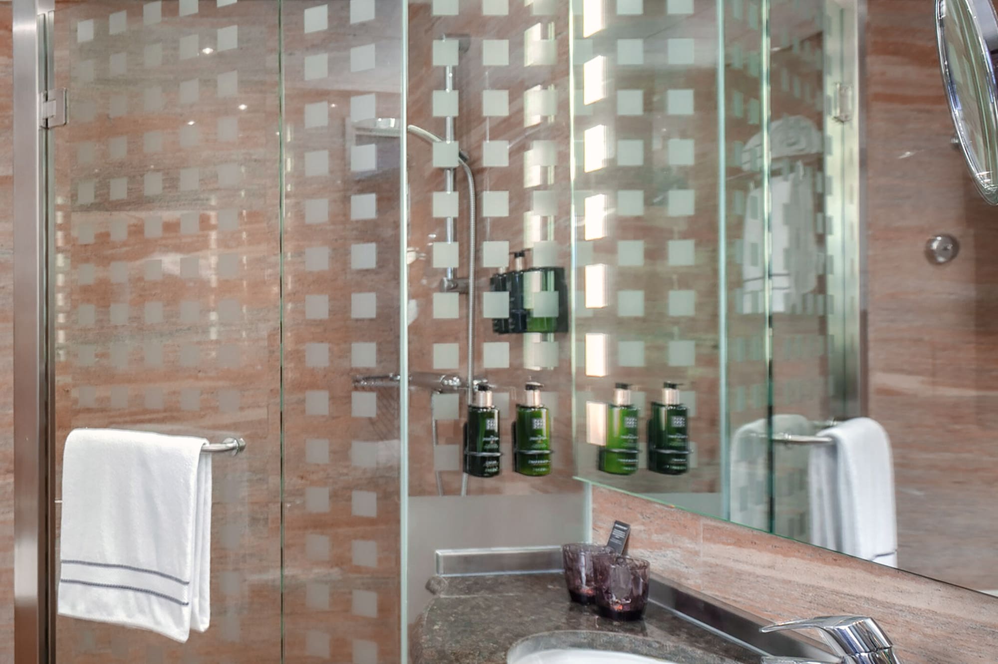 a bathroom with a glass shower and sink