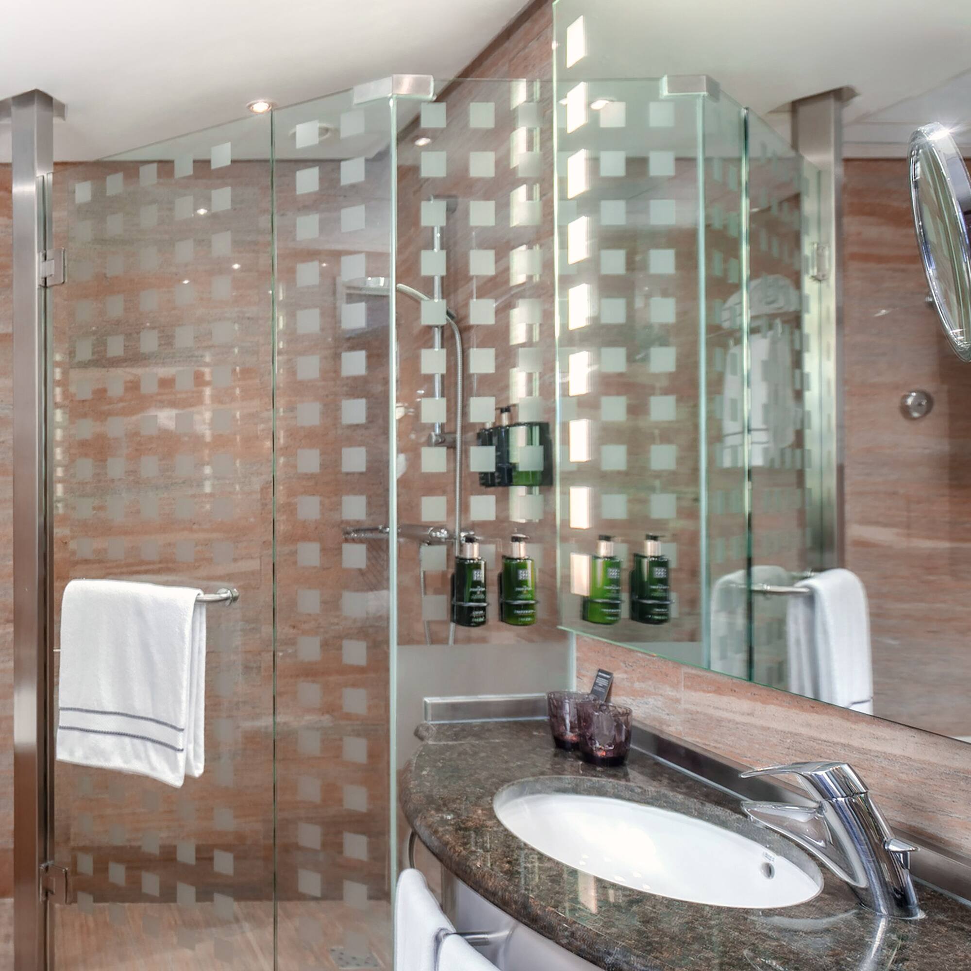 a bathroom with a glass shower and sink