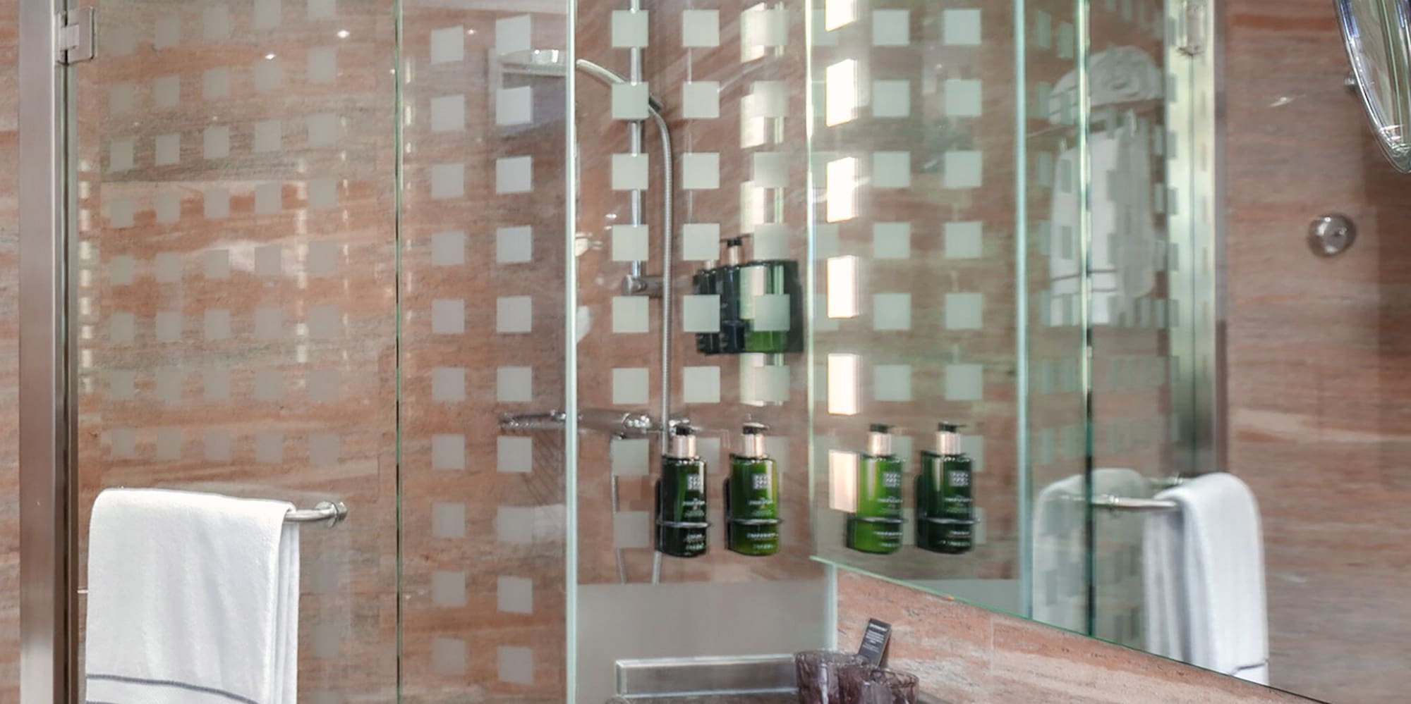 a bathroom with a glass shower and sink