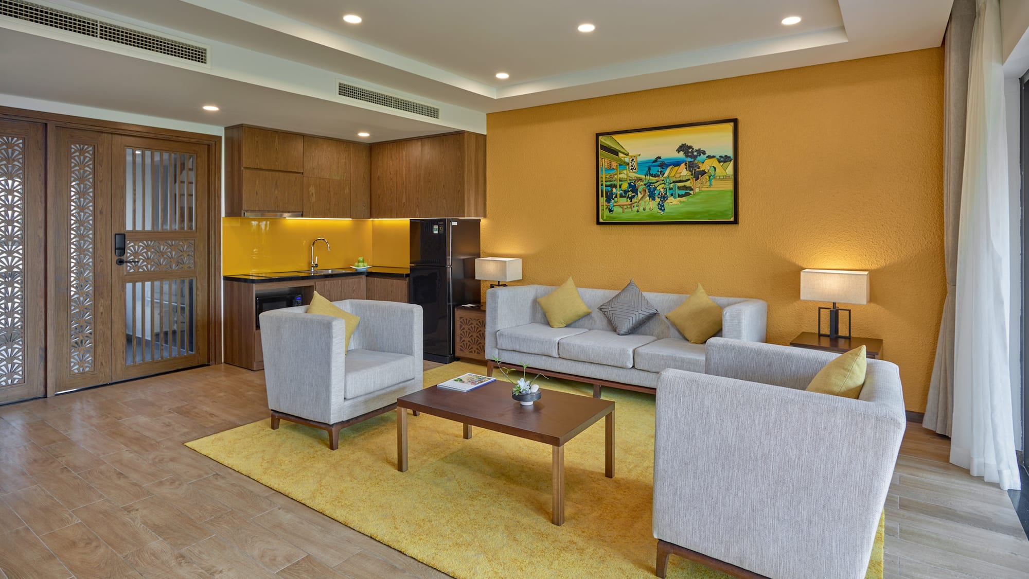 a living room with a yellow wall and white furniture