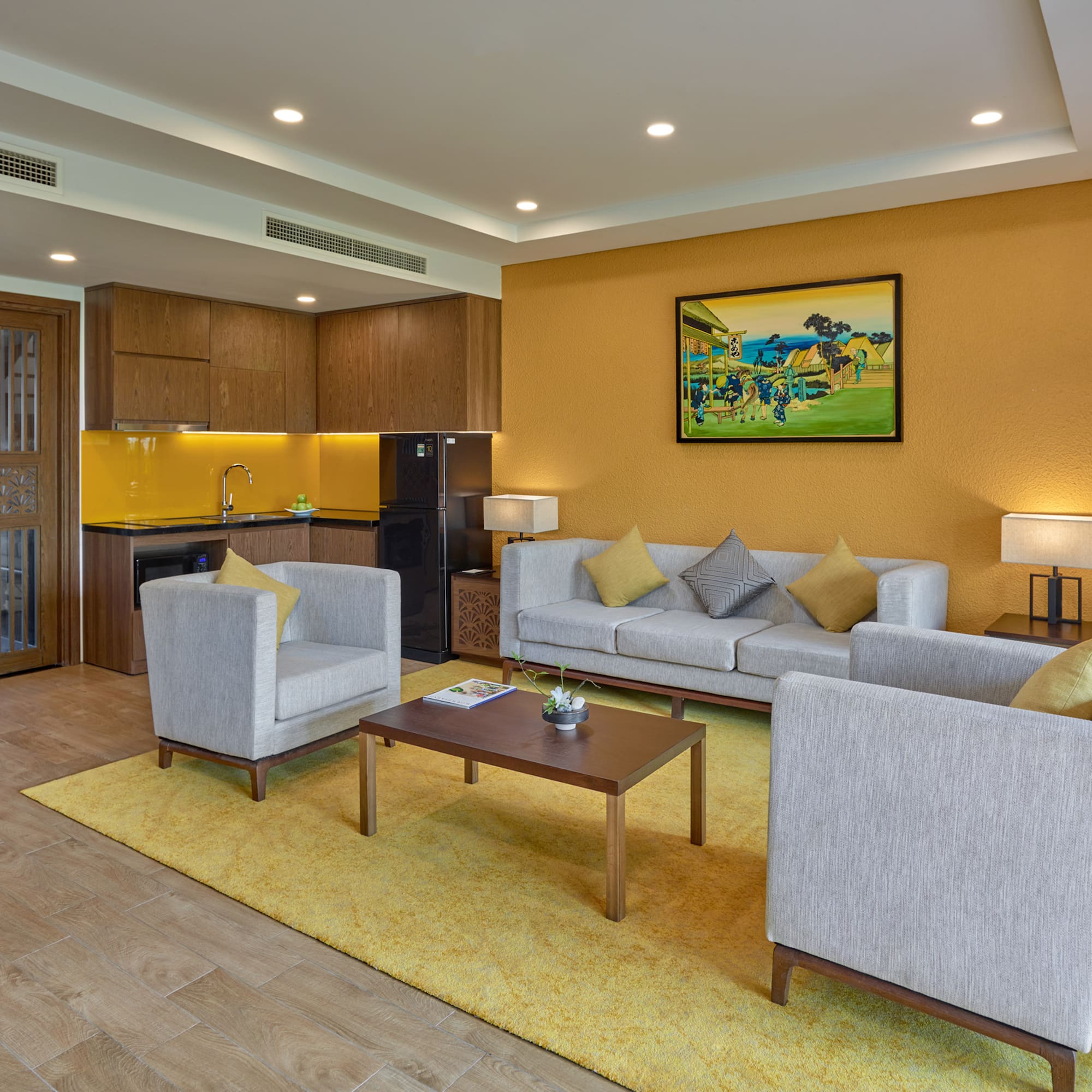 a living room with a yellow wall and white furniture