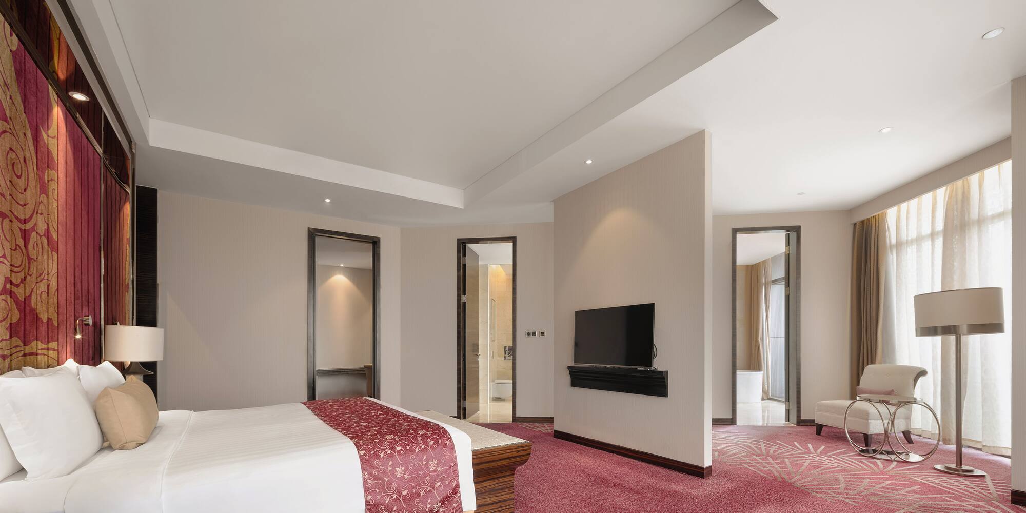 a room with a bed and a television