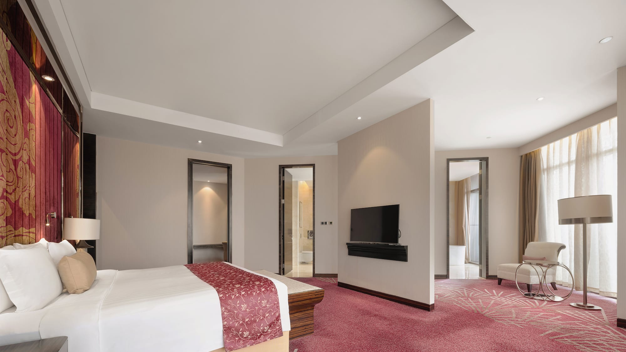 a room with a bed and a television