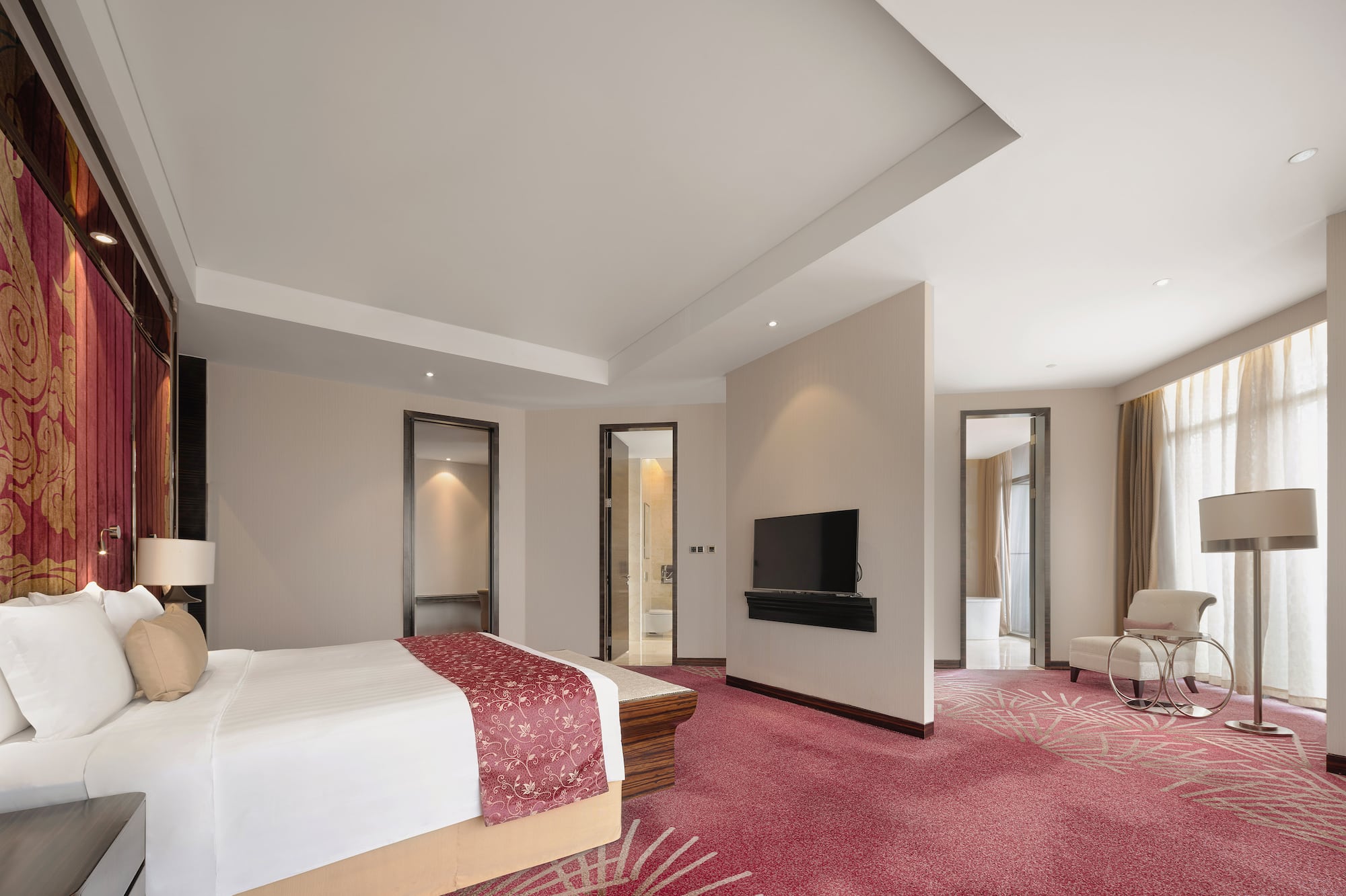 a room with a bed and a television