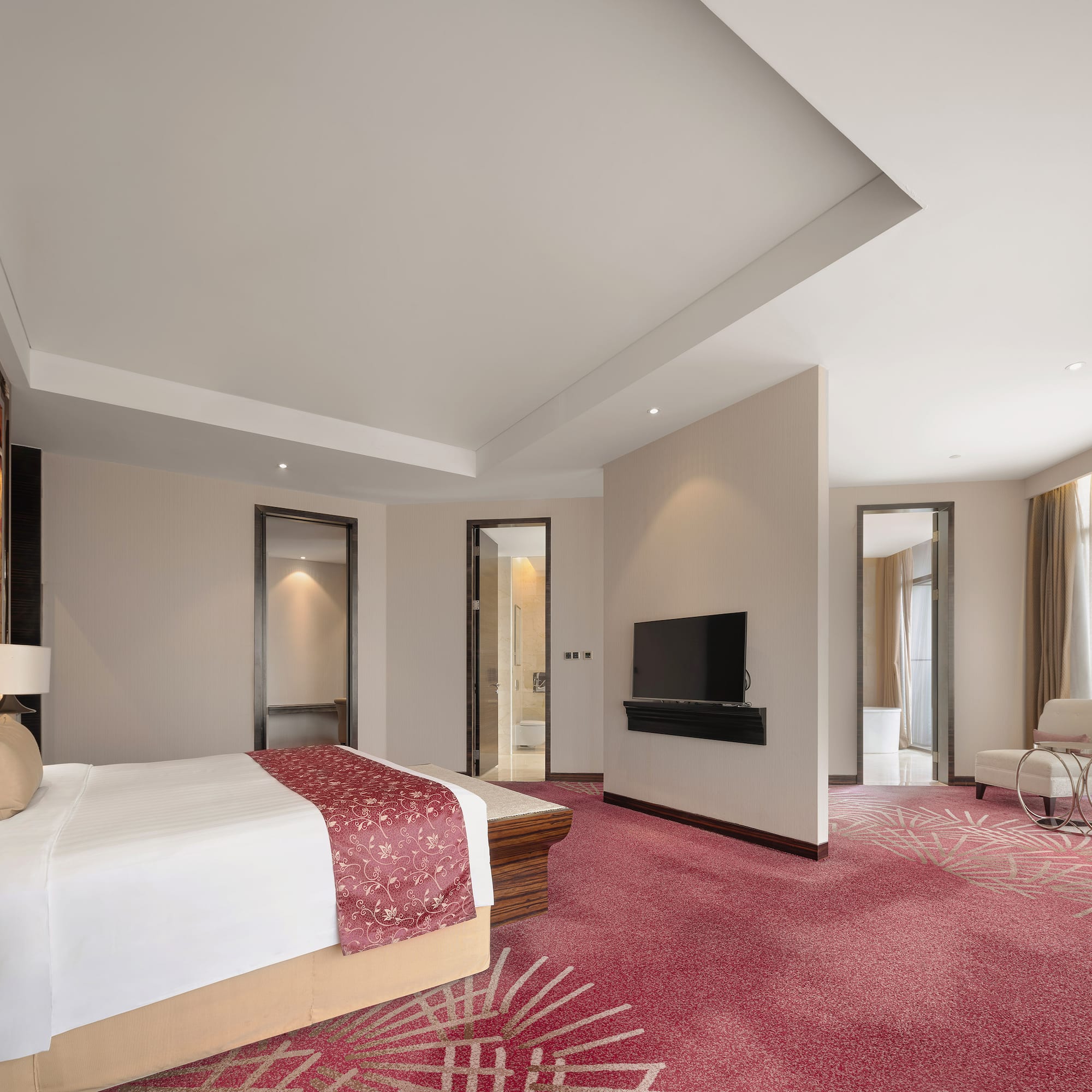 a room with a bed and a television