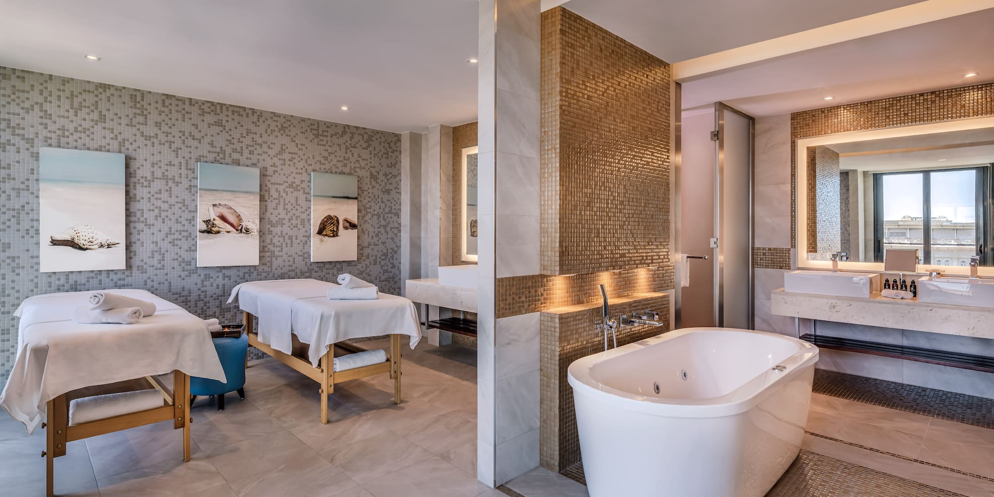 a room with a bathtub and sinks