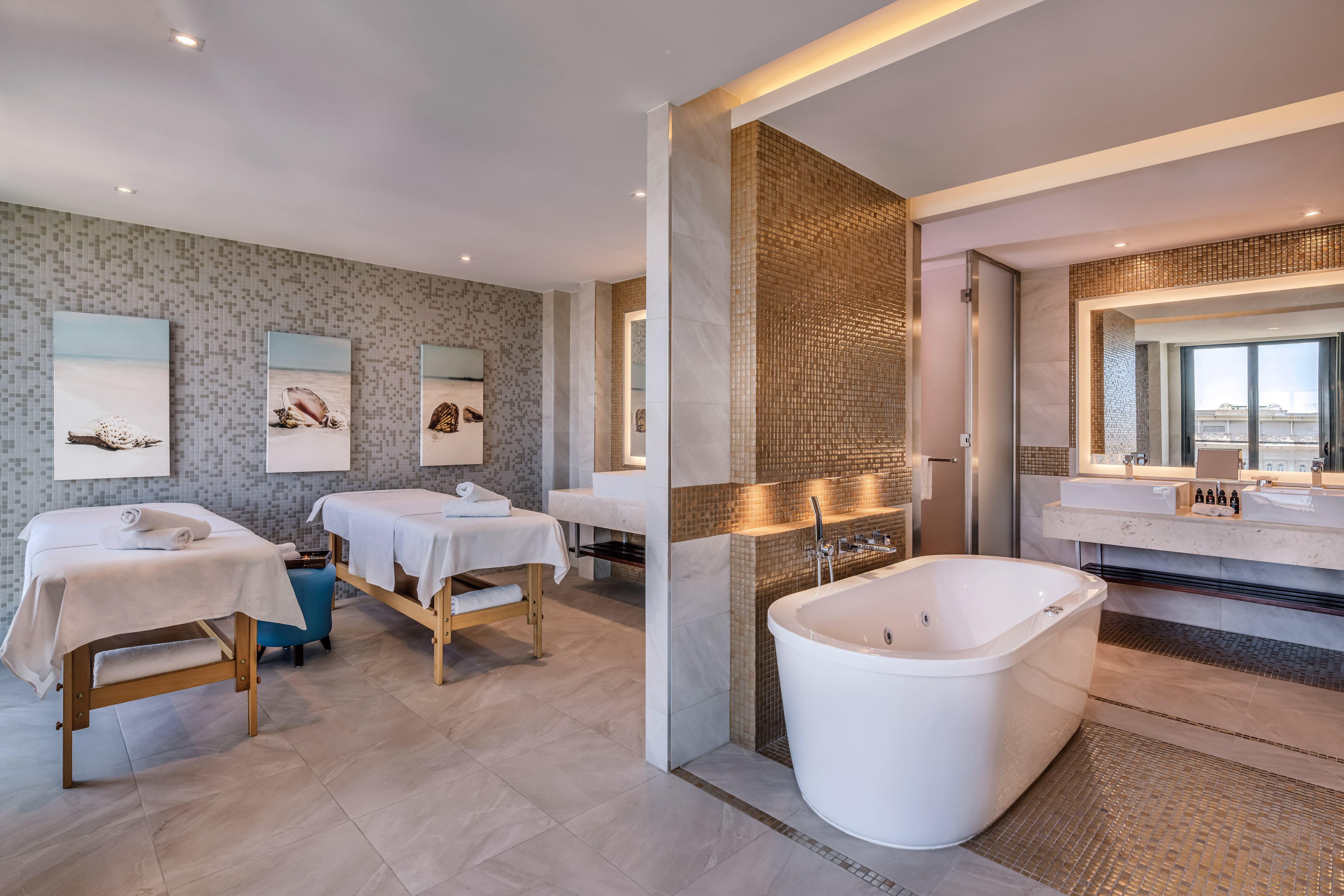 a room with a bathtub and sinks