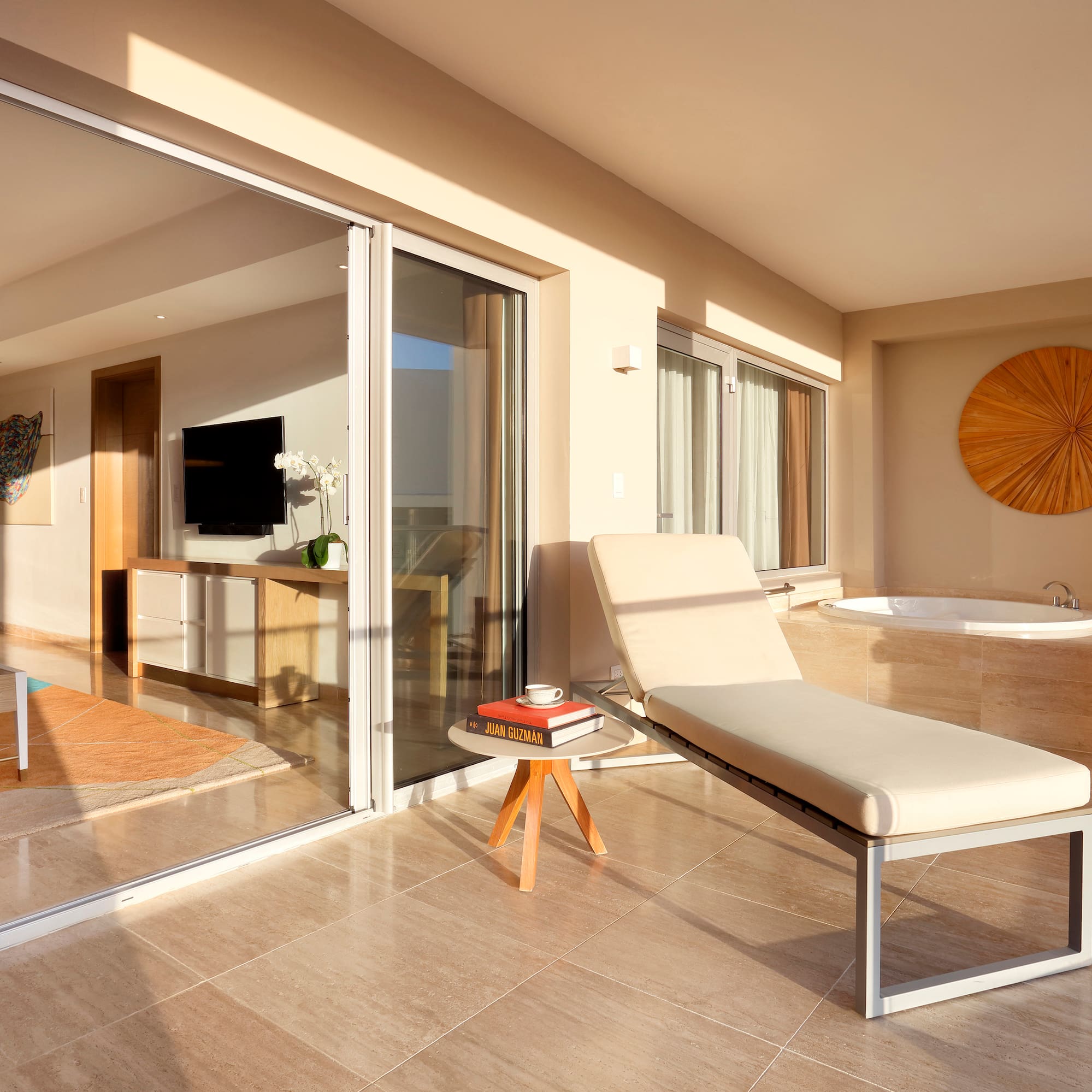 a lounge chair in a room with glass doors