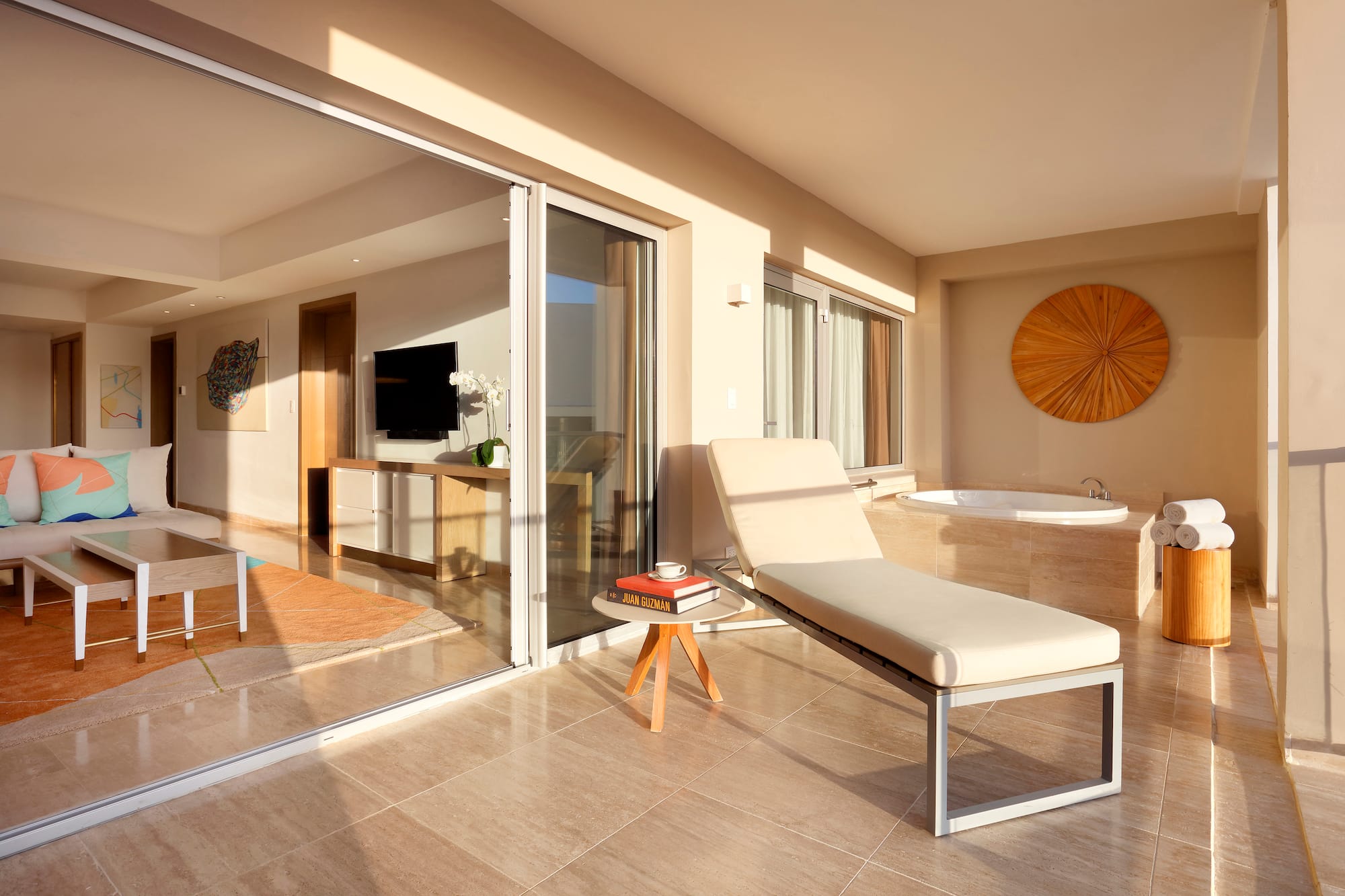 a lounge chair in a room with glass doors