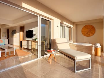 a lounge chair in a room with glass doors