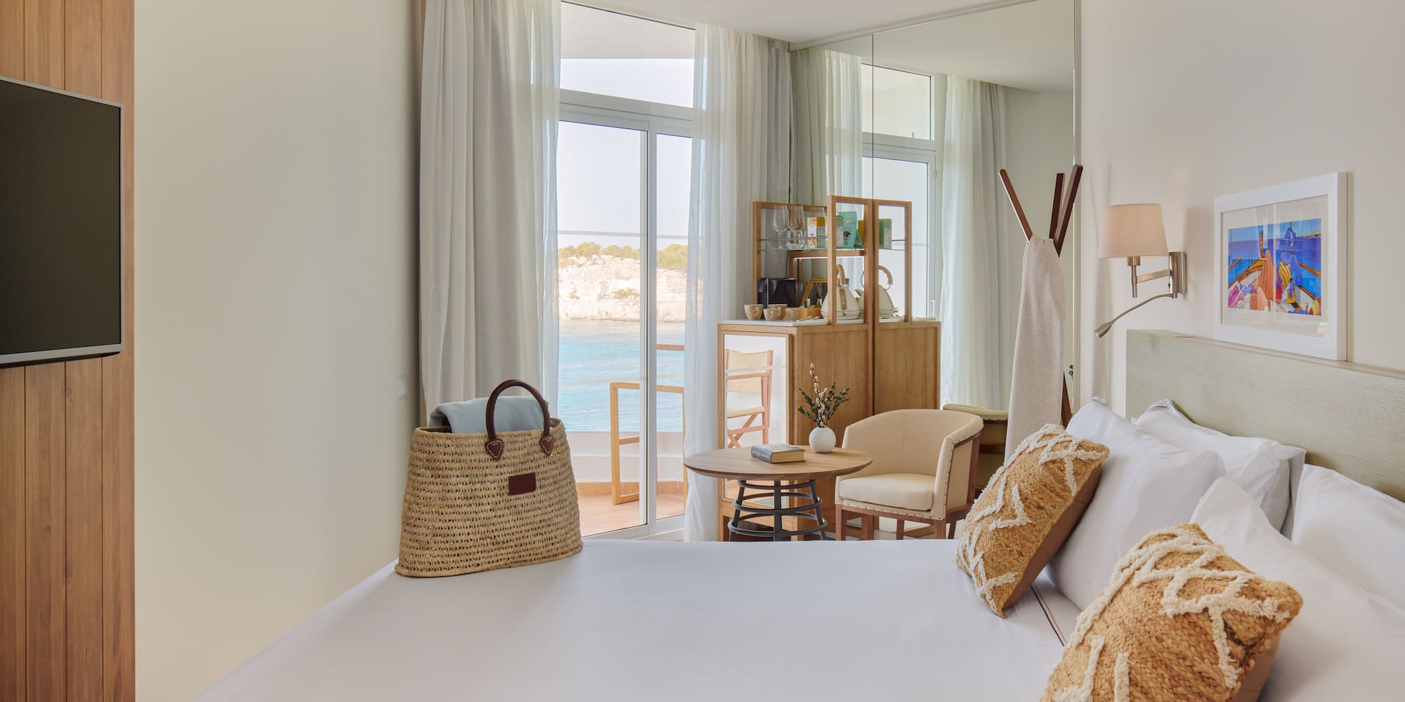 a room with a bed and a table and chairs