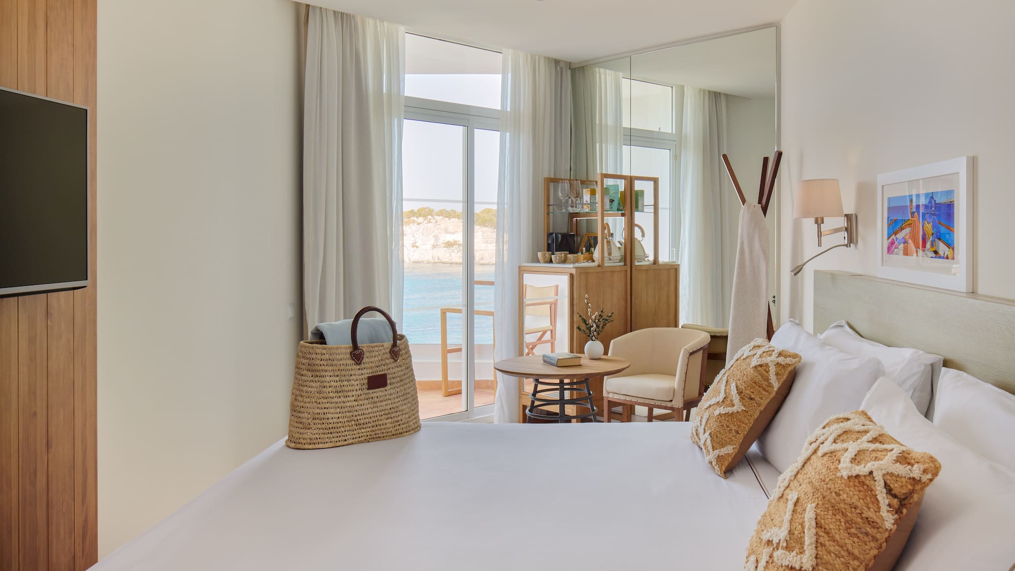 a room with a bed and a table and chairs