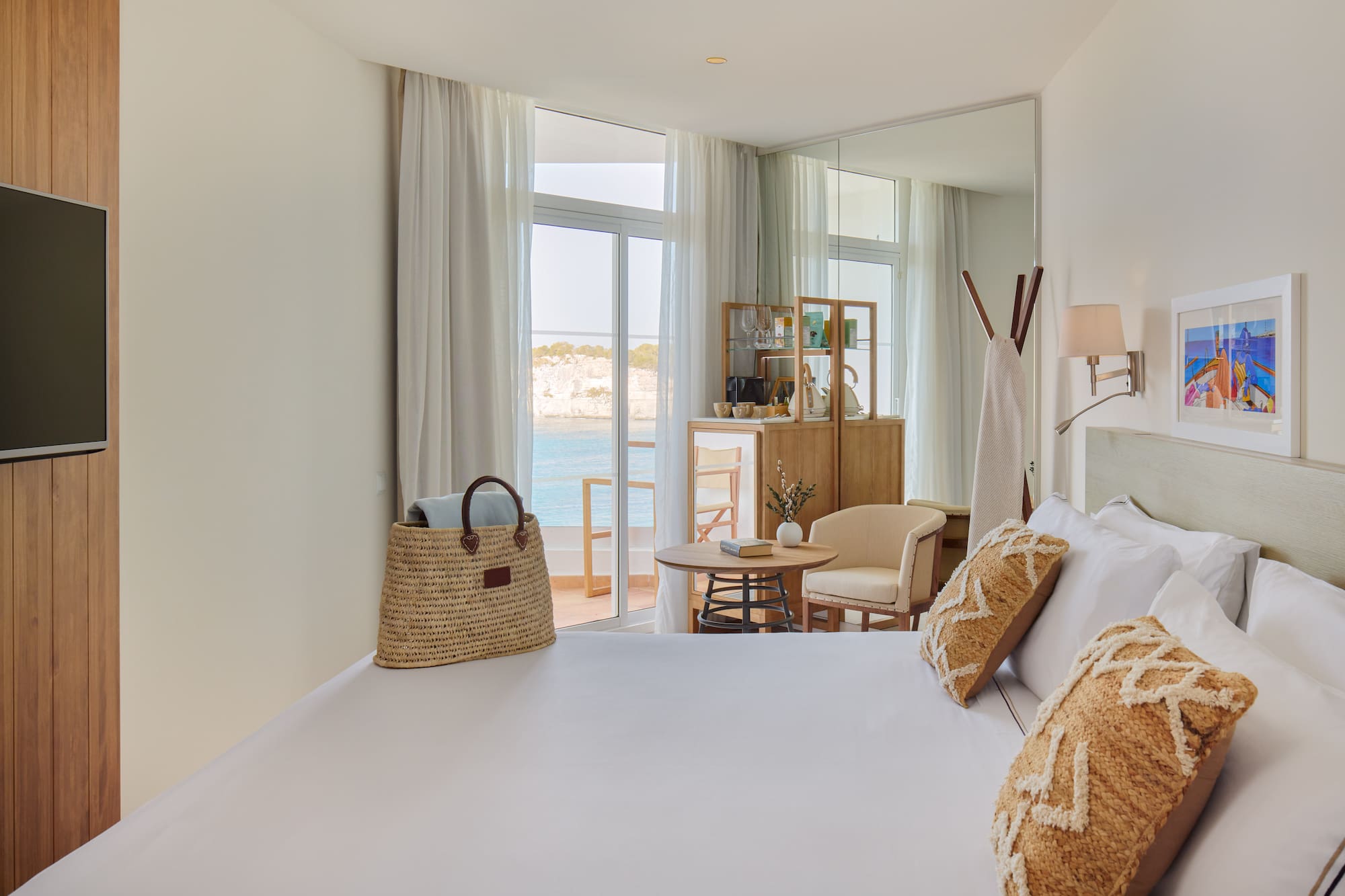 a room with a bed and a table and chairs