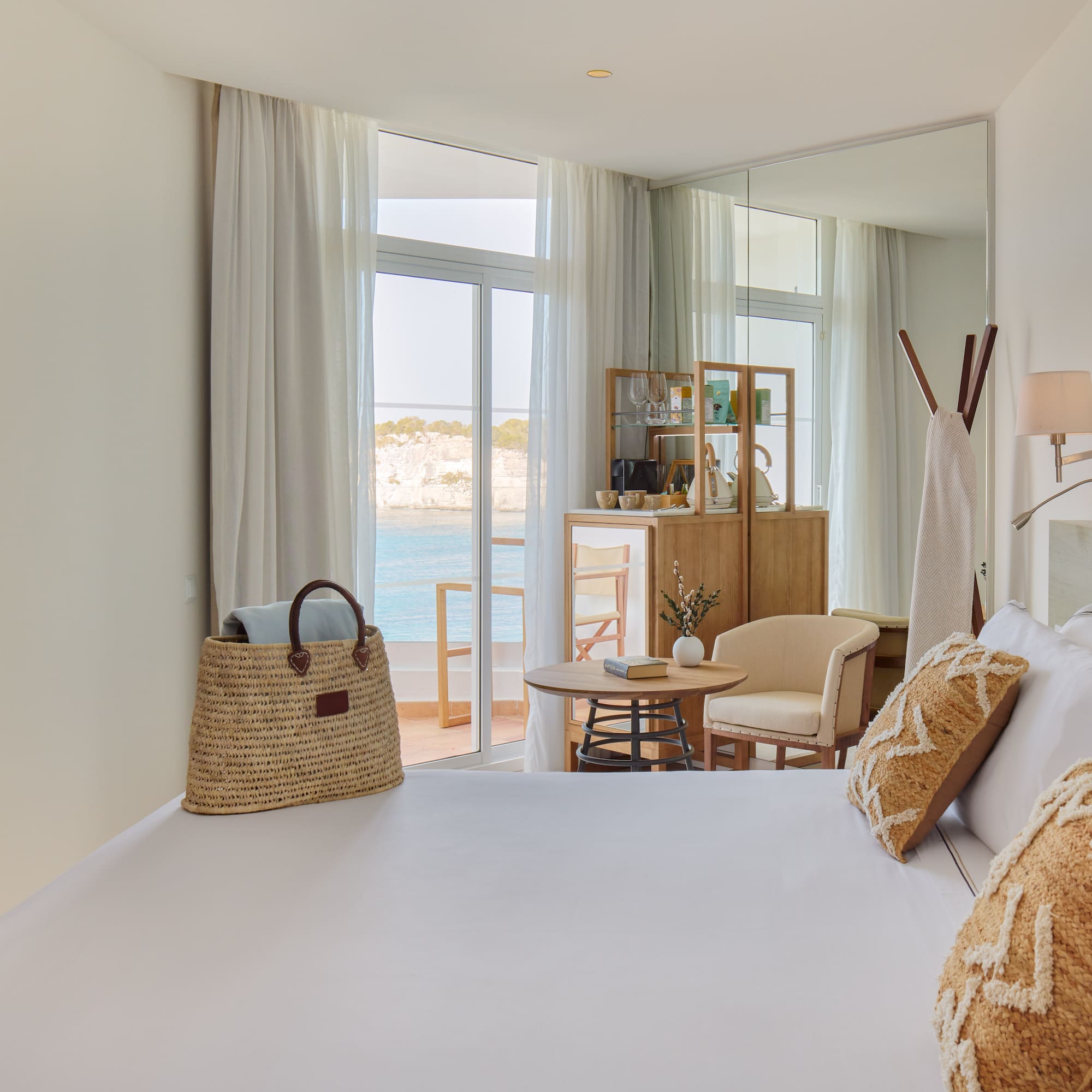 a room with a bed and a table and chairs