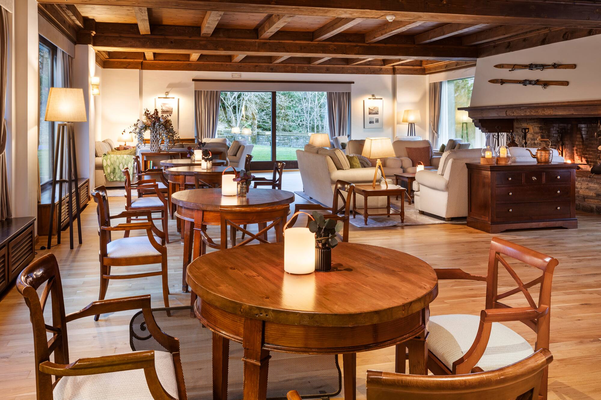 Rustic ski lodge lounge with warm fireplace, wooden beams, and comfortable seating.