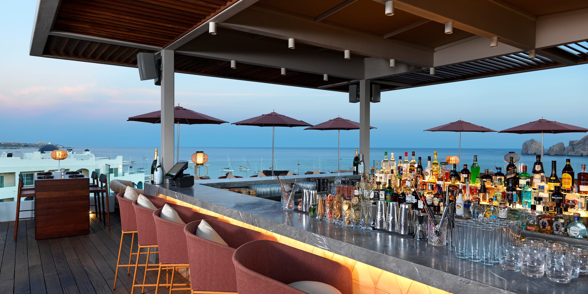 a bar with chairs and umbrellas