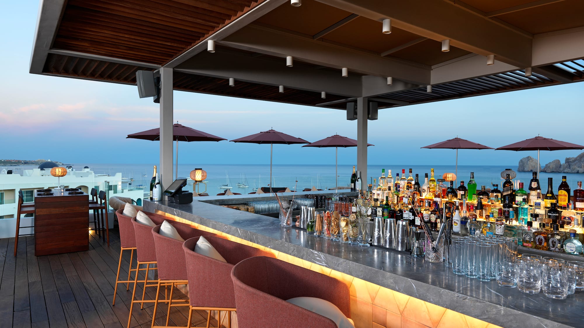 a bar with chairs and umbrellas