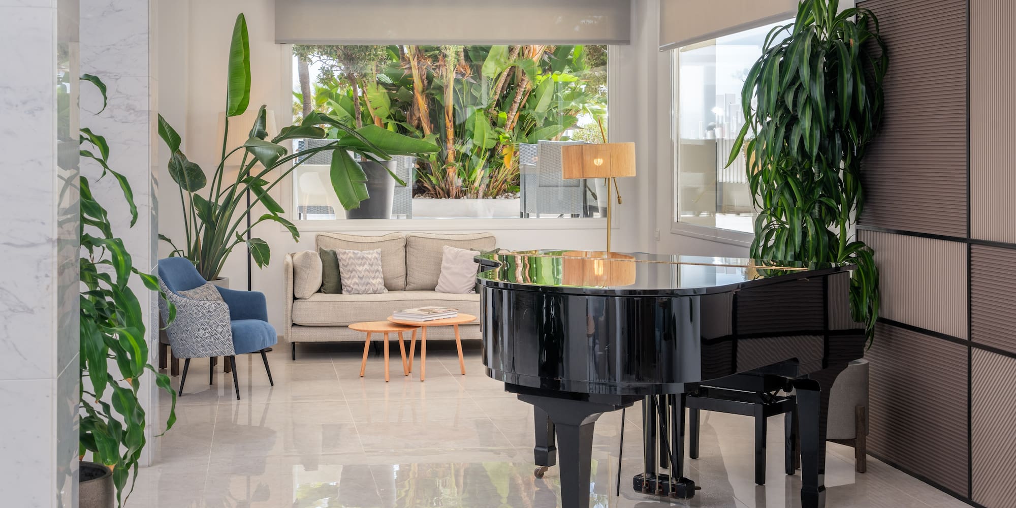 a room with a piano and plants