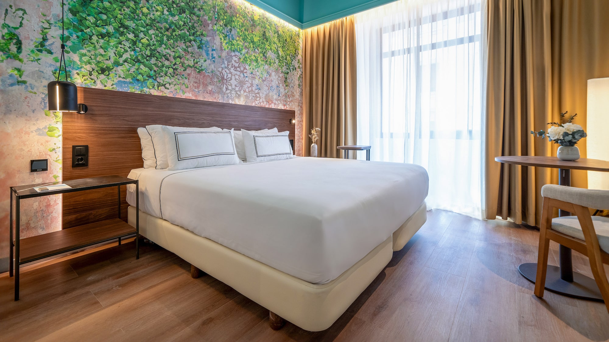 a bed with white sheets and a wood headboard in a room with a window