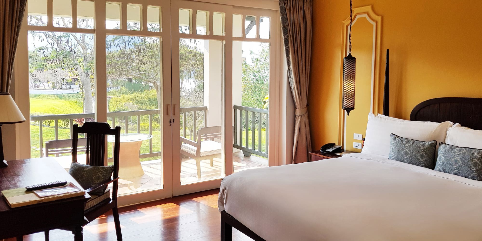 a bedroom with a door to a patio