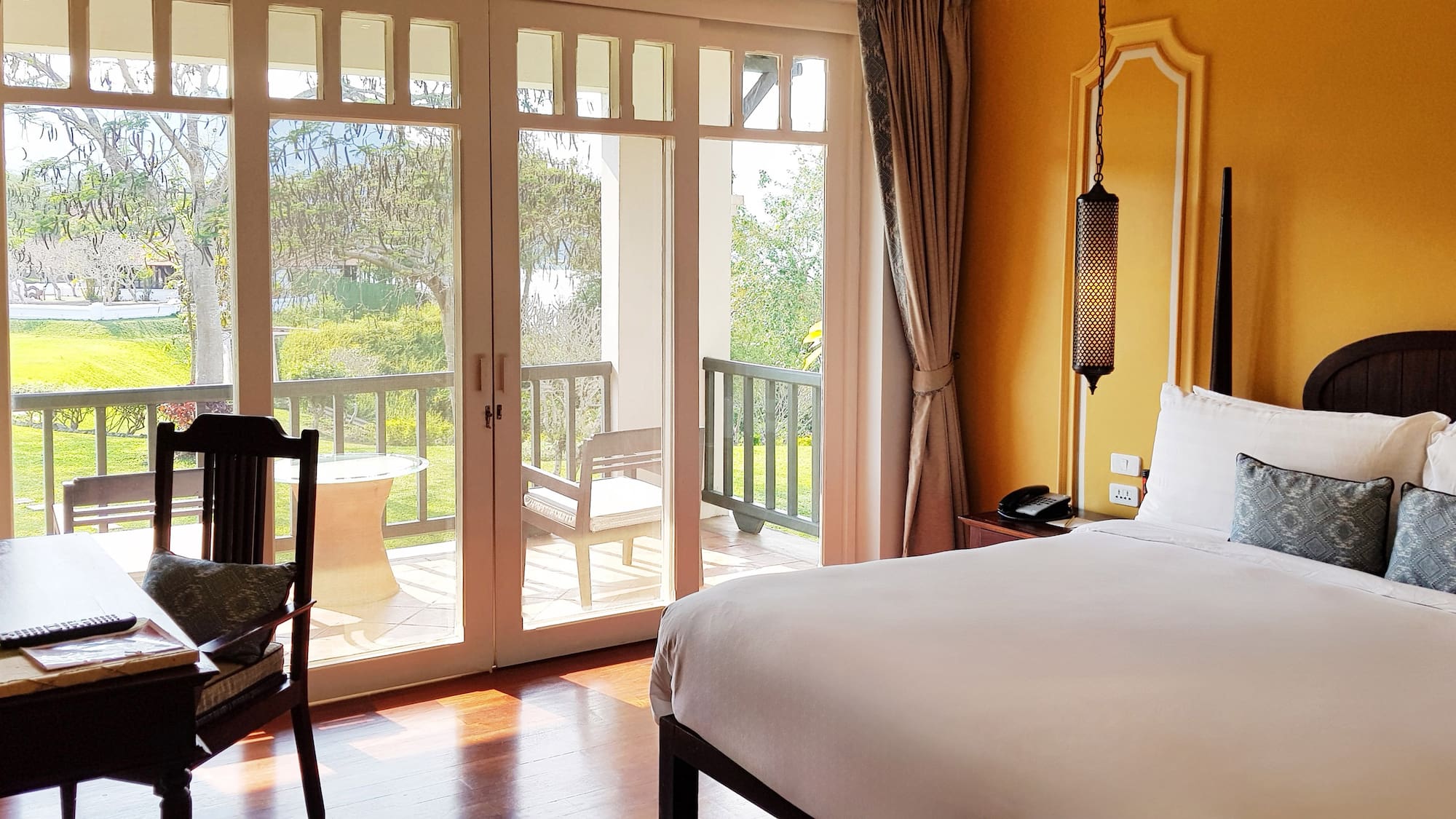 a bedroom with a door to a patio