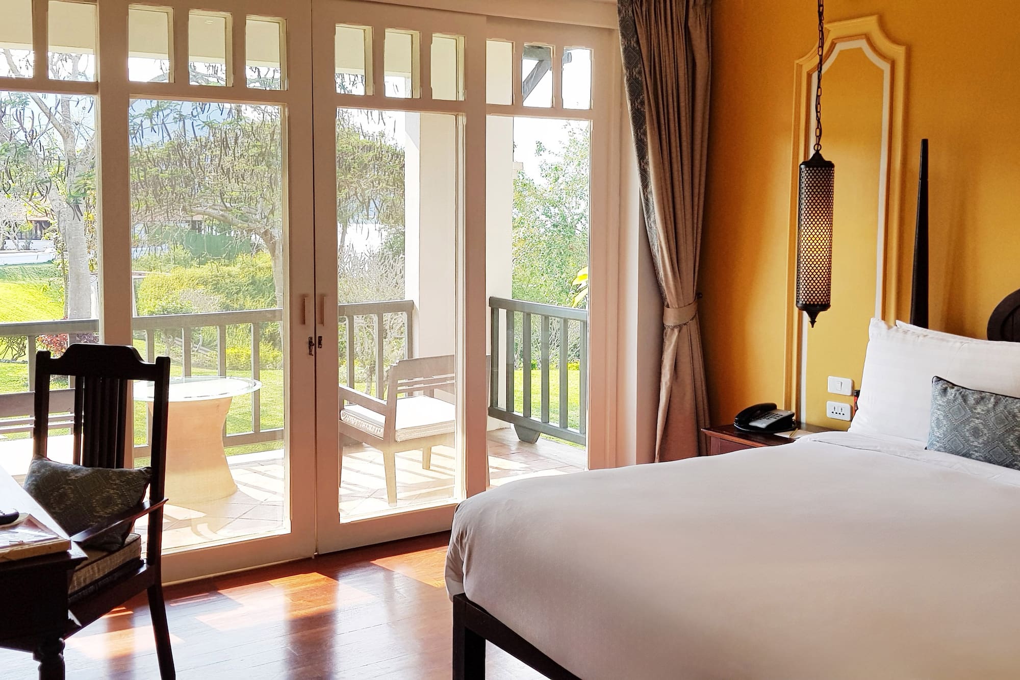 a bedroom with a door to a patio