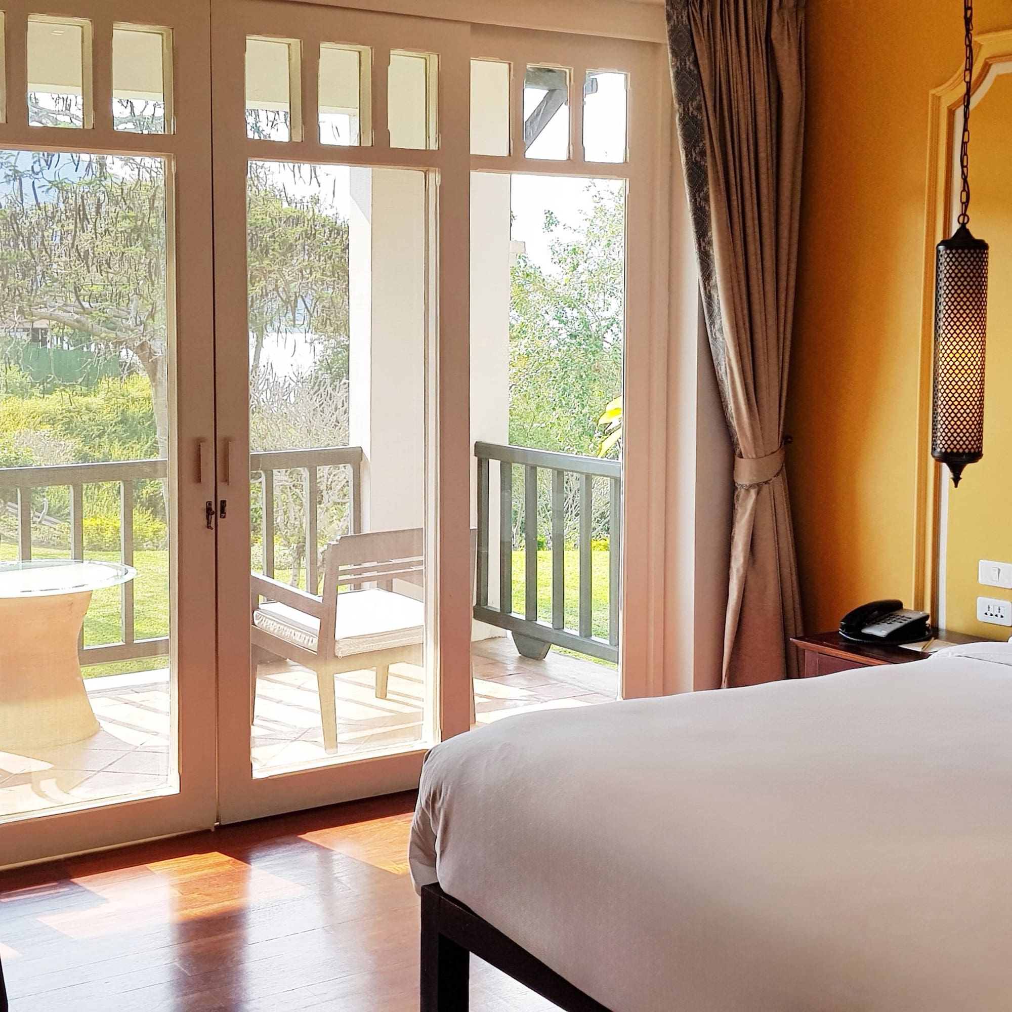 a bedroom with a door to a patio