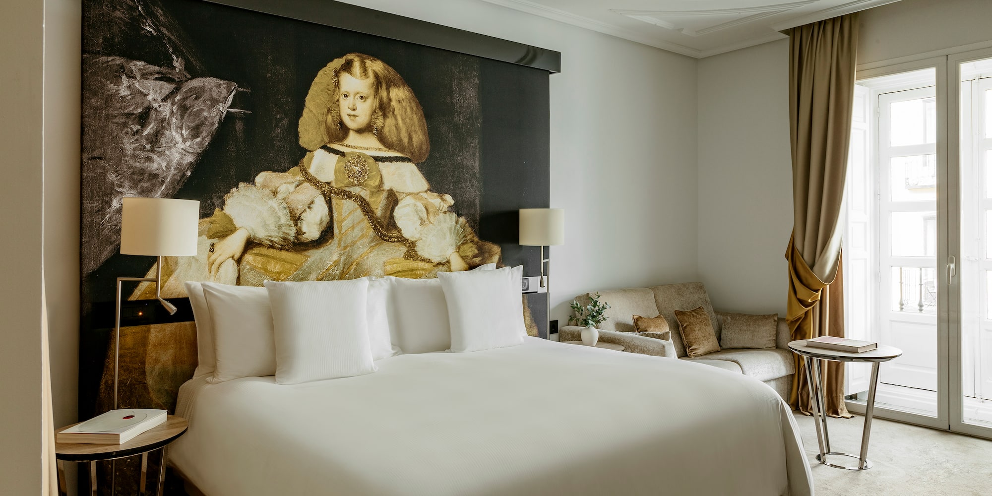 a room with a bed and a painting on the wall