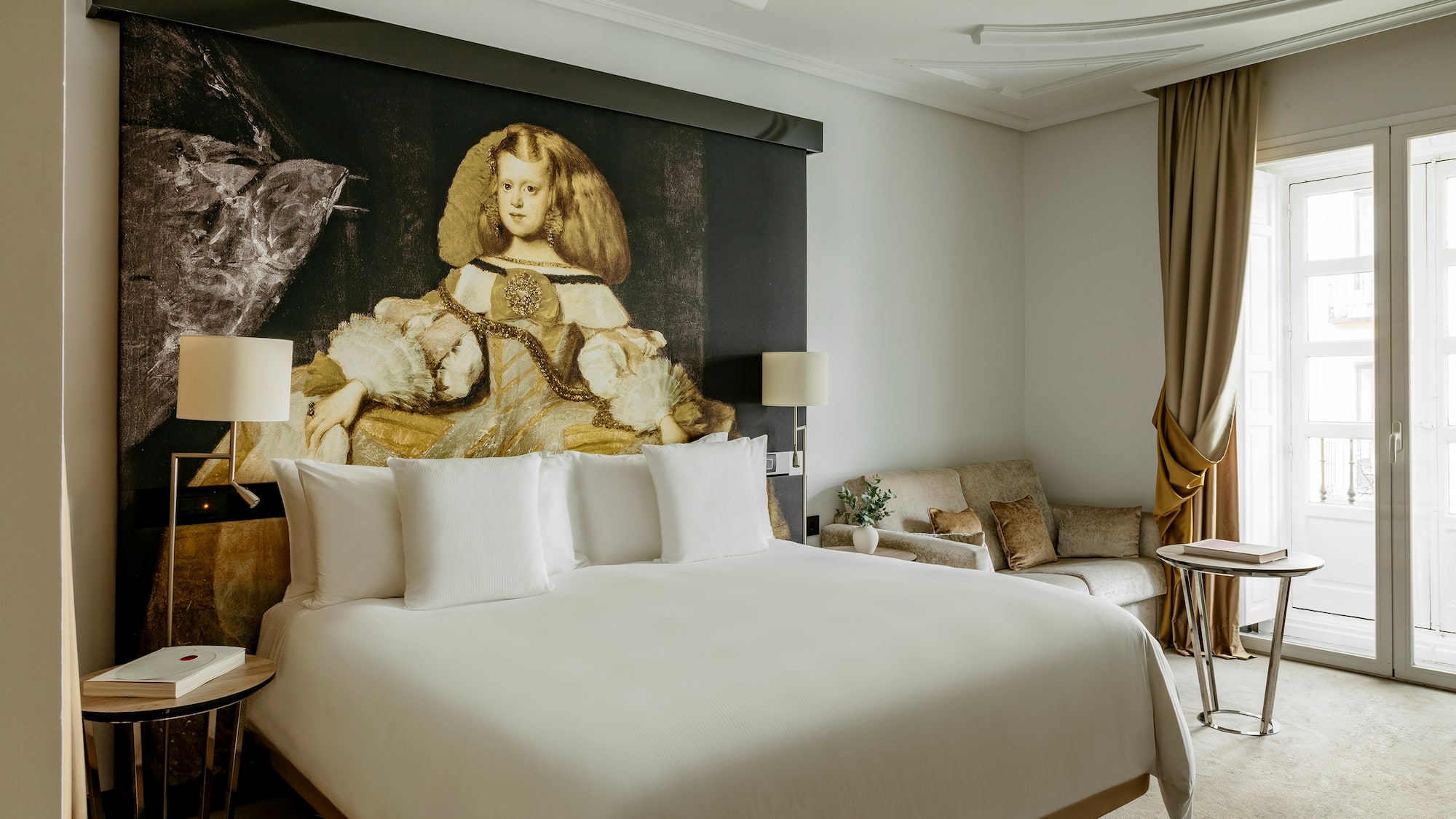 a room with a bed and a painting on the wall