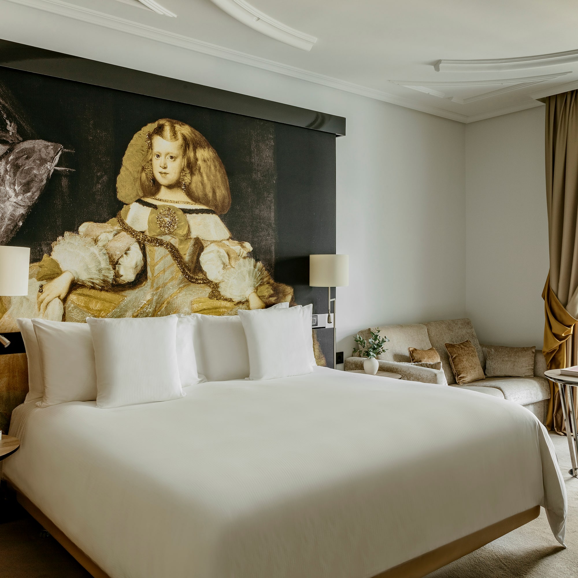 a room with a bed and a painting on the wall