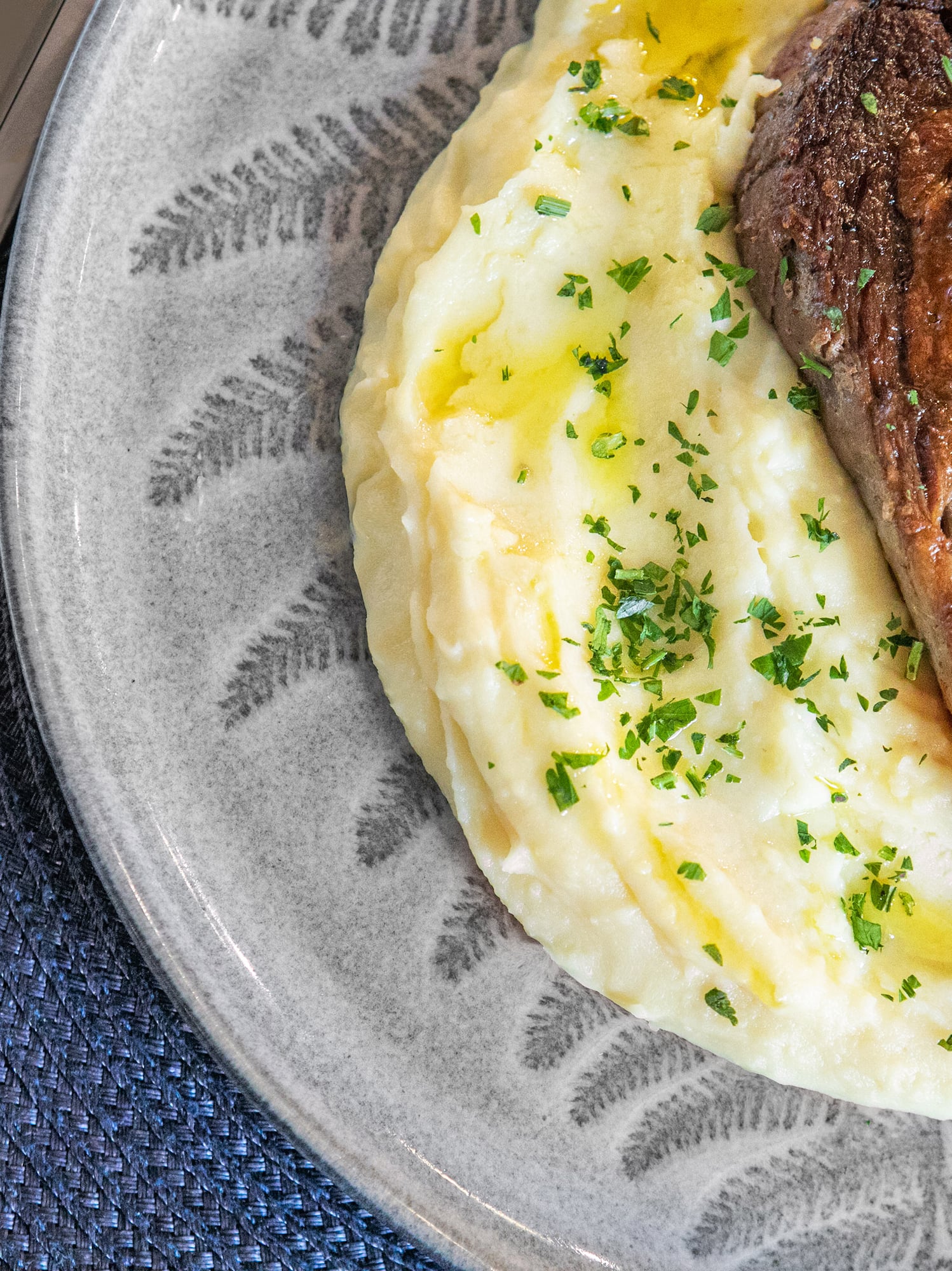 a steak and mashed potatoes on a plate