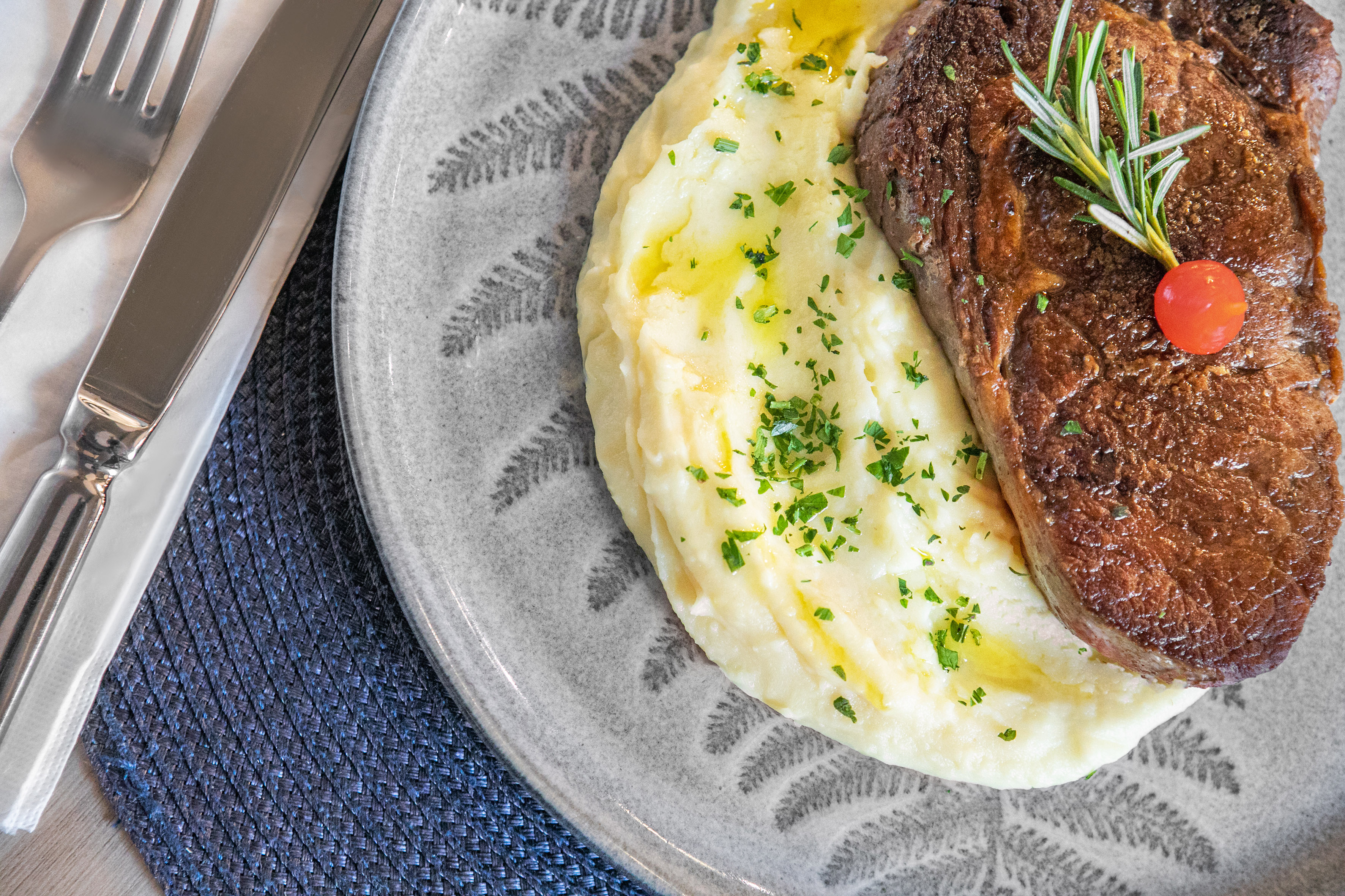 a steak and mashed potatoes on a plate