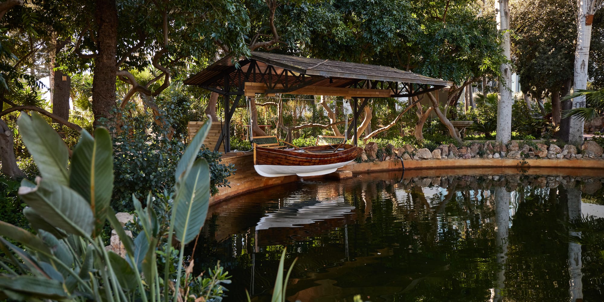 a boat on a dock by a pond