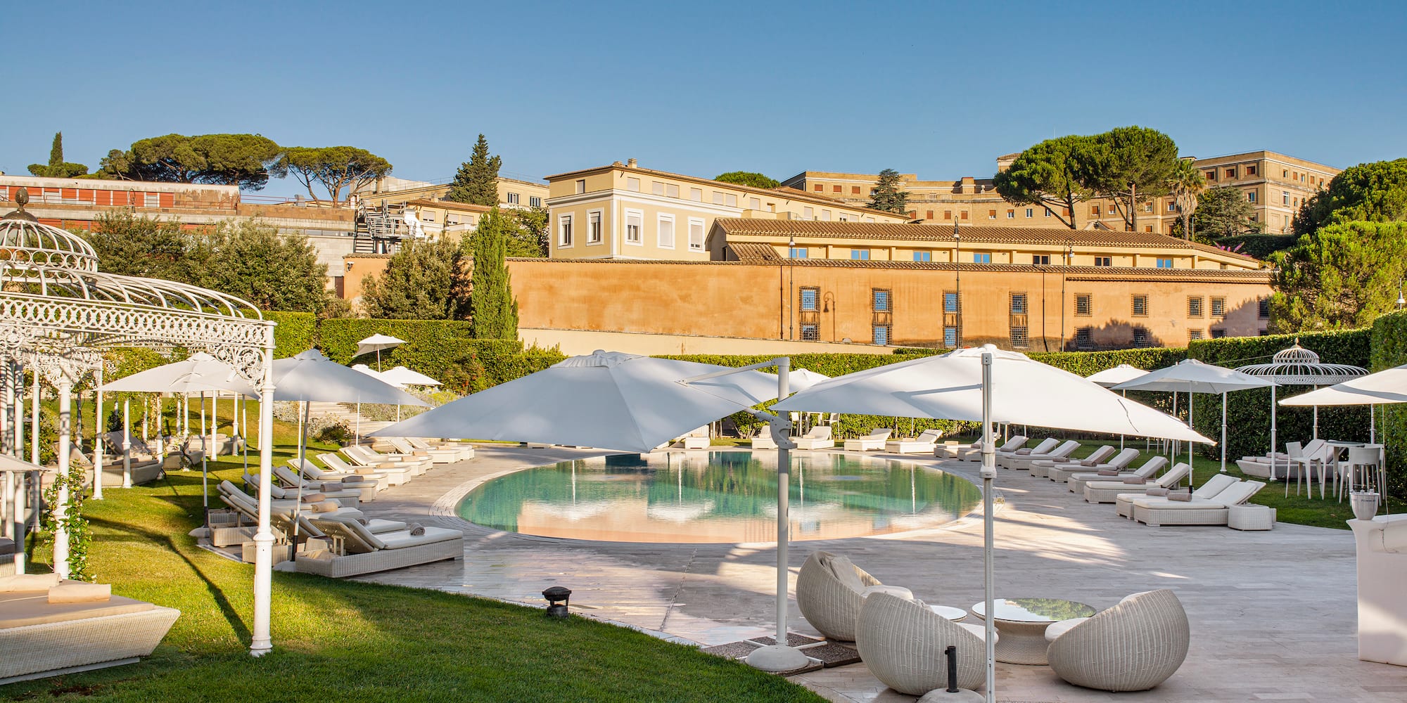a pool with lounge chairs and umbrellas