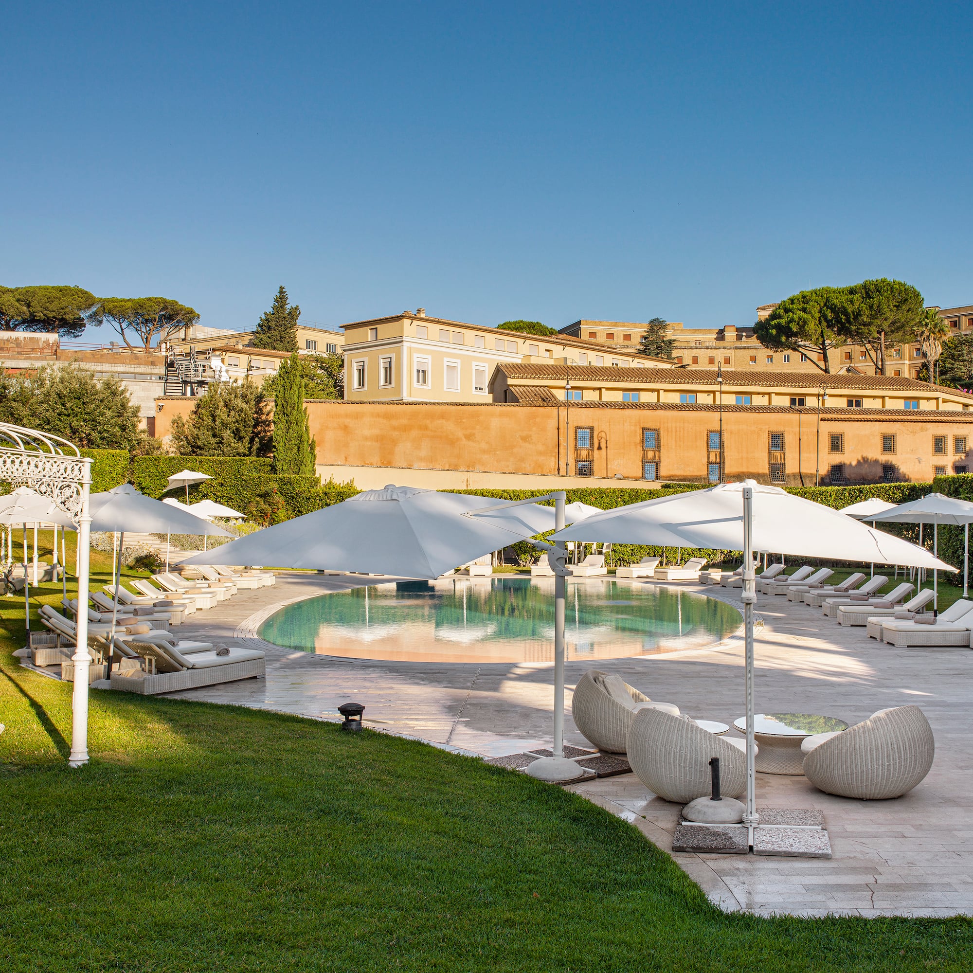 a pool with lounge chairs and umbrellas