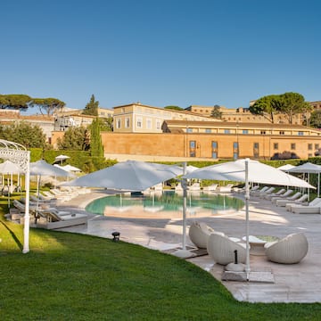 a pool with lounge chairs and umbrellas