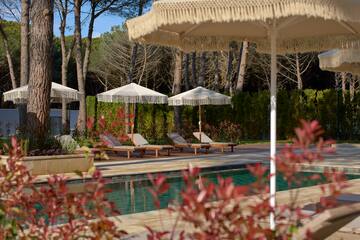 a pool with chairs and umbrellas